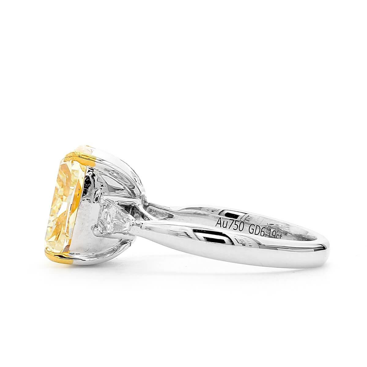 Natural, untreated 6.19 carat main light yellow diamond, surrounded by smaller white diamonds making up a total of 6.56 Carats. Cushion Shape. This piece has been expertly crafted using 18 Karat White Gold. 

This piece can be adjusted or resized.