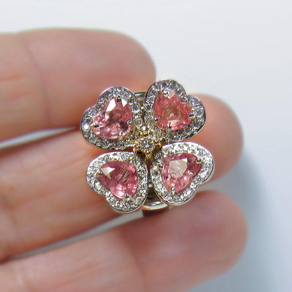 This Stunning GIA certified Padparadscha Sapphire flower ring is set with four heart cut sapphire Padparadscha, weighing over 5.20 carats. Average color/clarity Sapphire: Pinkish-Orange/ VS. These gorgeous sapphires are accented with 1.00 carat of