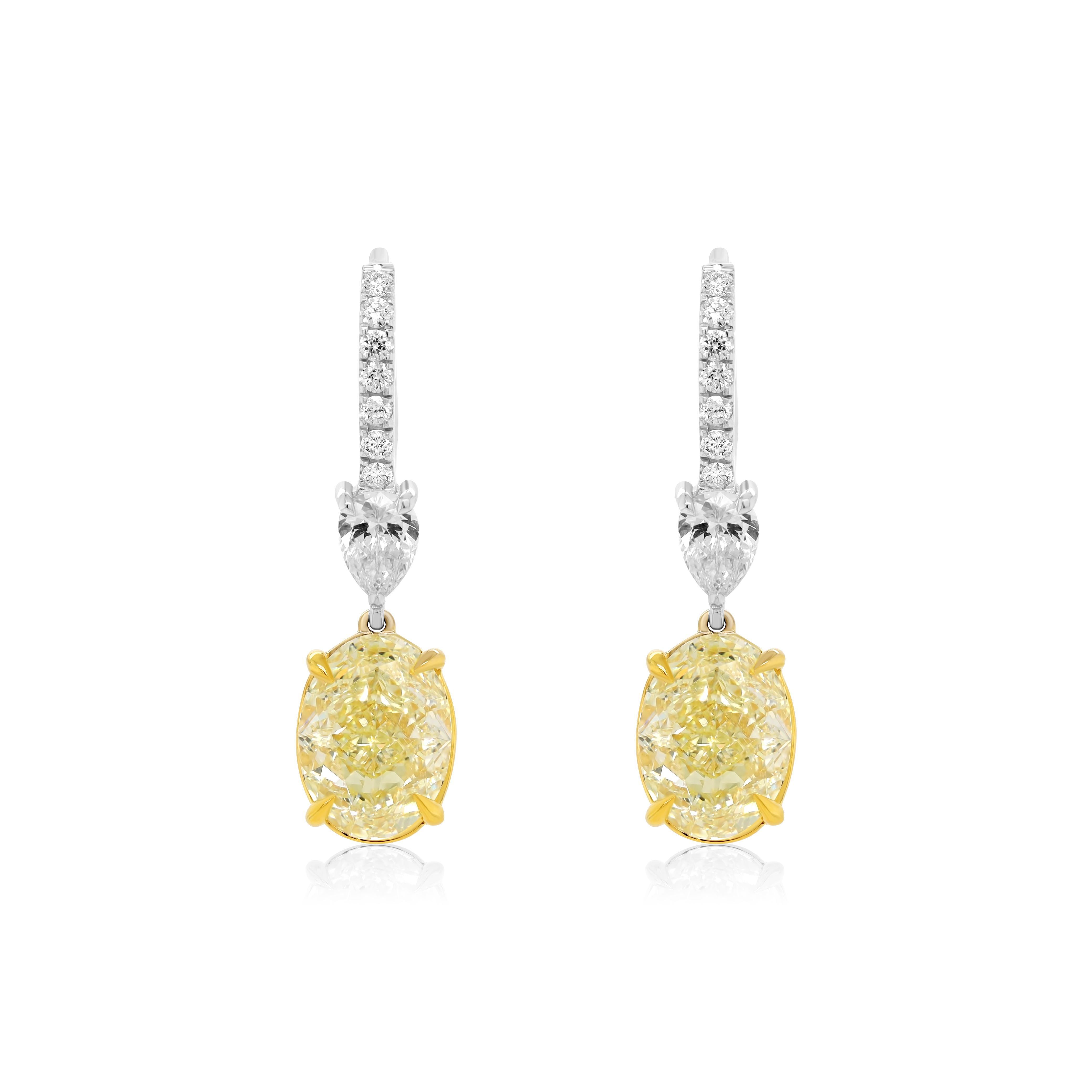 Fancy Yellow Oval Shaped Diamond Handing Earrings features 6.22 total diamonds weight, each diamond is GIA Certified. 
These beautiful diamond earrings set in Platinum and 18K Yellow Gold, each diamond is GIA Certified Oval Shaped Yellow Diamonds.