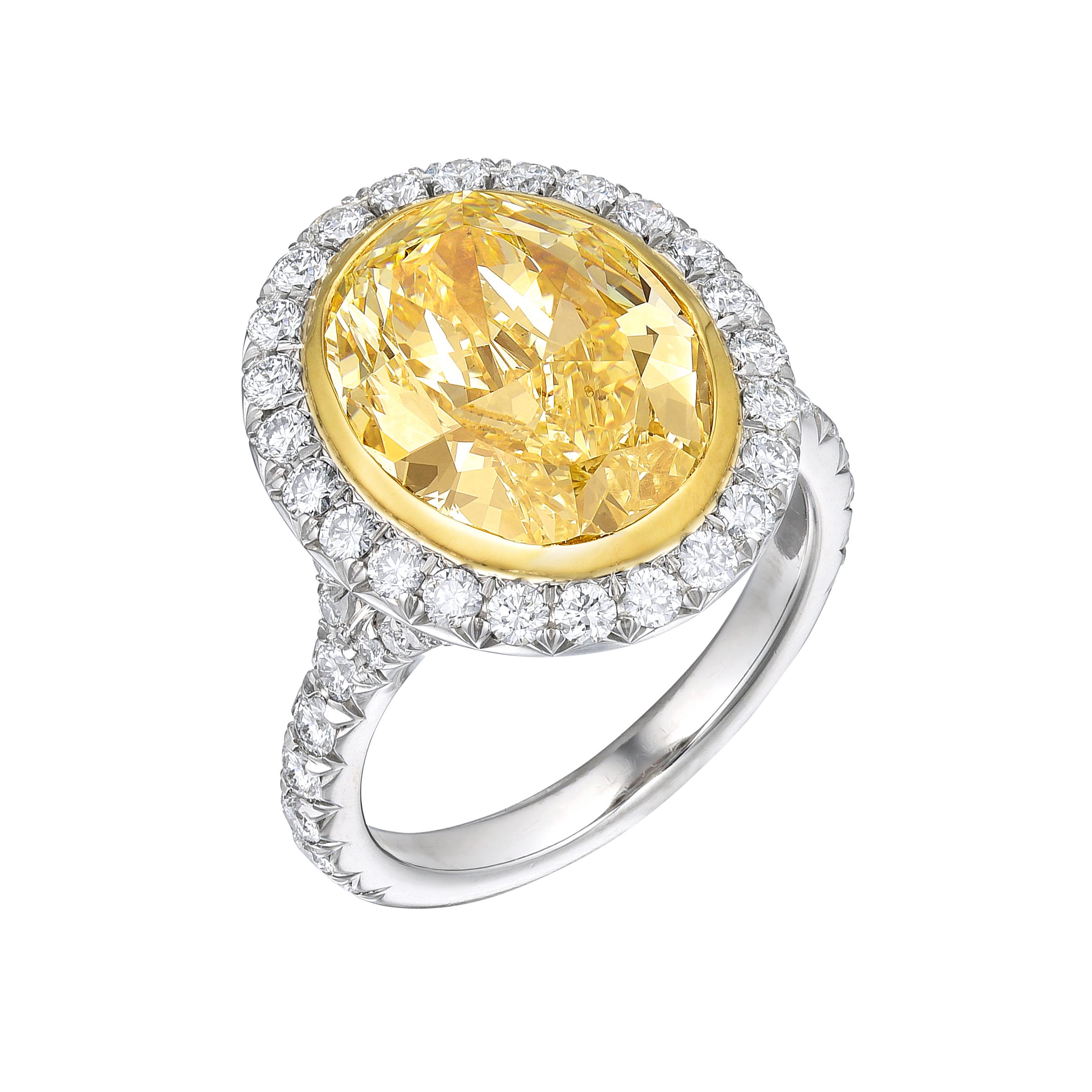 Diamond Platinum Fancy Yellow Ring, with GIA certificate no.2165961005, 5.12ct Fancy Yellow VS2 Oval cut natural diamond, 13 x 10mm. Side stones: 1.10ct. Brilliant Round: F-G VS2-SI1, set in french micro-pave style. Total carat weight: 6.22ct.
