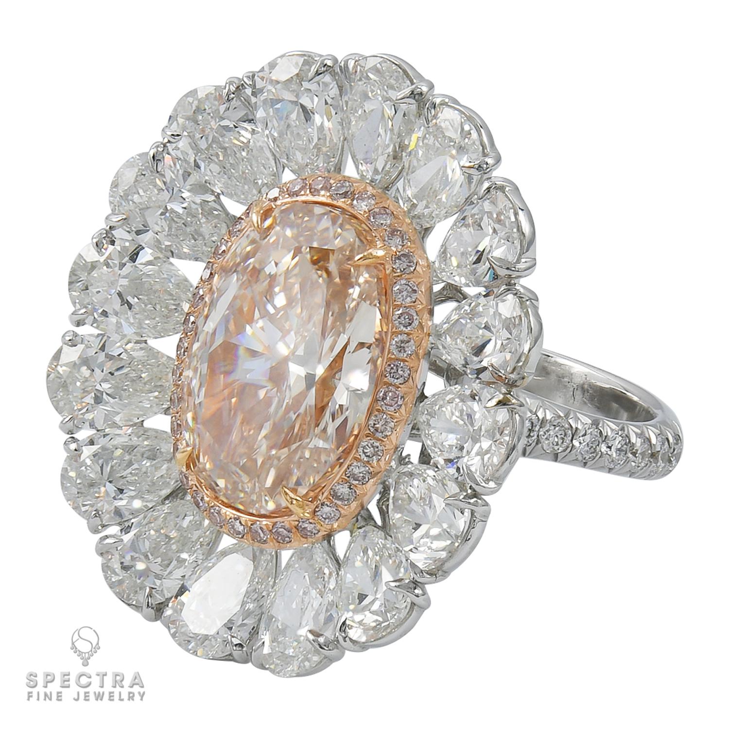 A stunning ring embellished with a 6.27 carat fancy pink-brown oval diamond and 16 pear shape diamonds weighing 6.63 carats. Pave diamonds on the band weighing 0.75 carats. Total weight of the diamonds is 13.65 carats.
The center diamond is