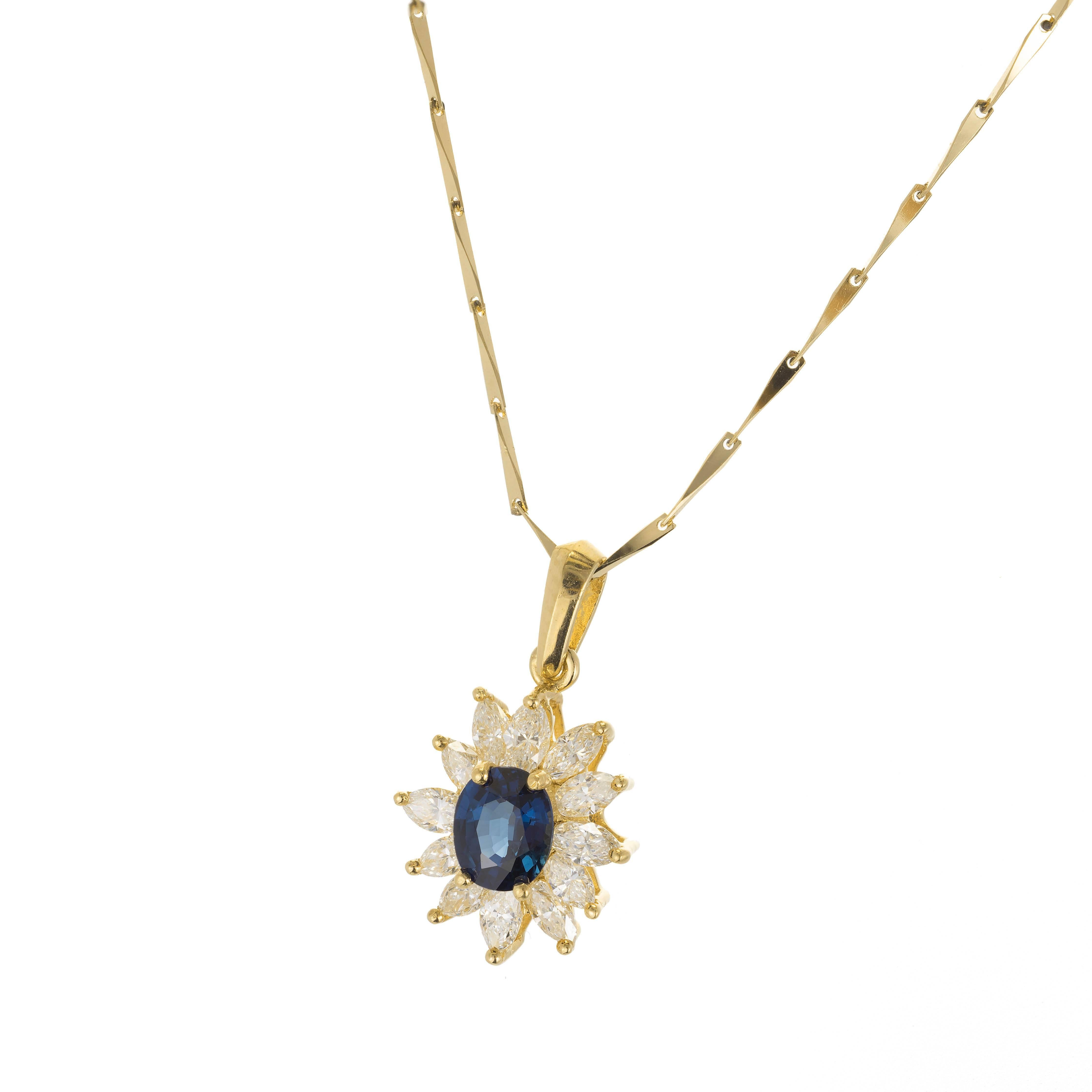 18k yellow gold sapphire and diamond pendant necklace. 18k wedged bar style link chain. An oval faceted blue sapphire is surrounded by a cluster of marquise shaped diamonds.

1 oval blue no heat sapphire 5.78 x 4.83 x 3.01 Approximate .63 carats GIA