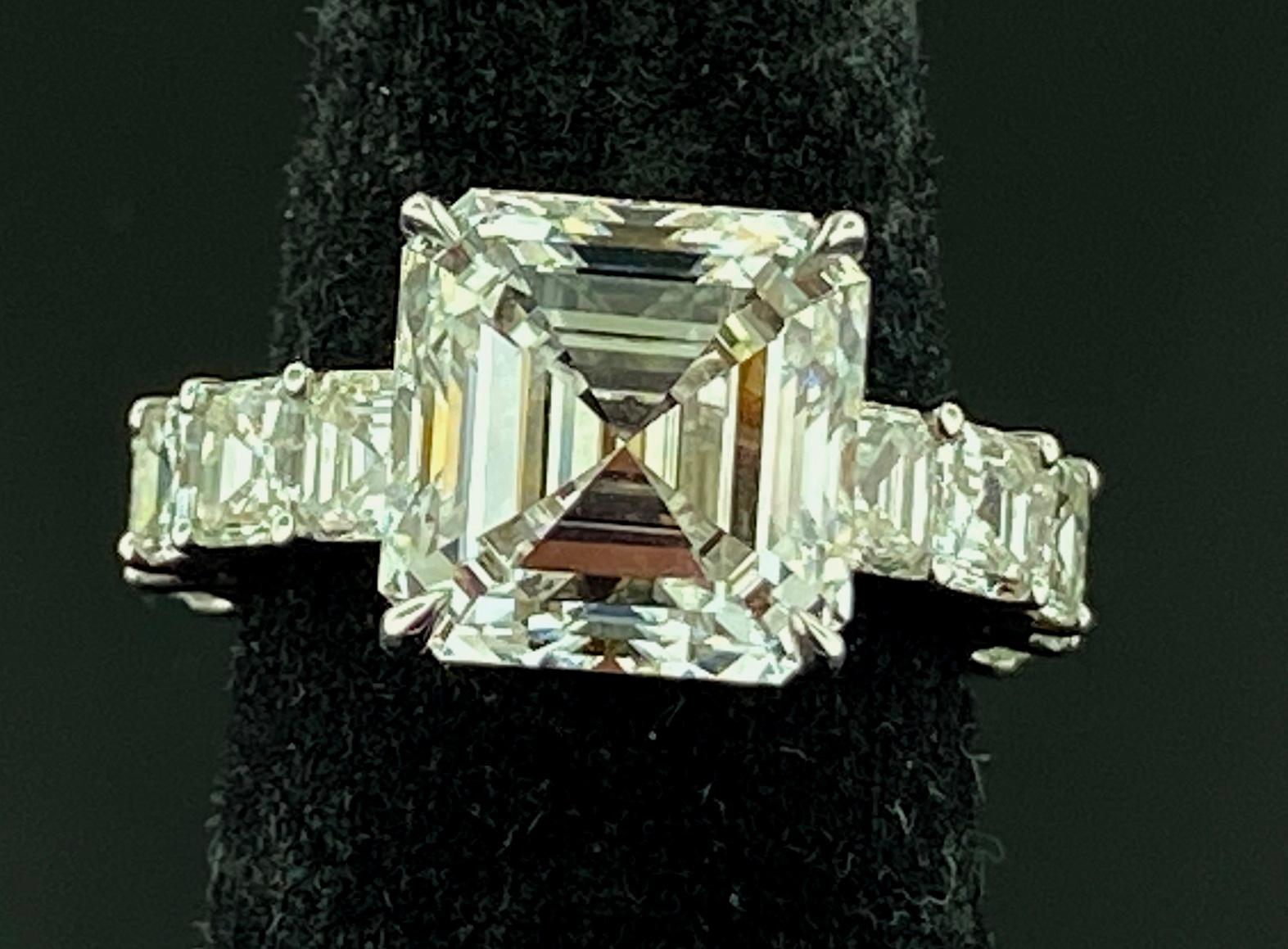Set in 18 karat white gold is a GIA Certified 6.23 carat Asscher cut Diamond.  Color is H, Clarity is VS-1.  The band has 16 Asscher cut stones with a total weight of 4.19 carats.  Ring size is 6.