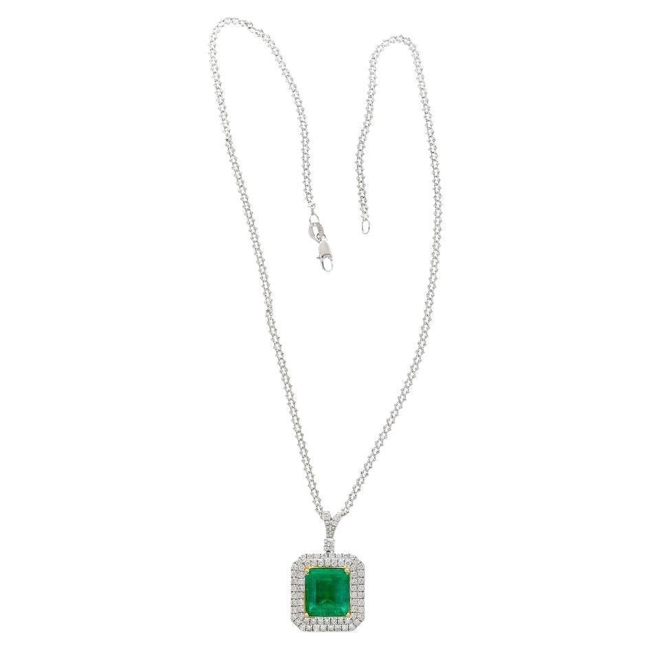 GIA certified 6.33 carat natural Colombian Emerald and diamond pendant necklace in 18k white gold. Set with 1.11 carats in round brilliant cut white diamonds that engulfing a vivid green natural emerald center stone. Fixed in a stunning cable chain