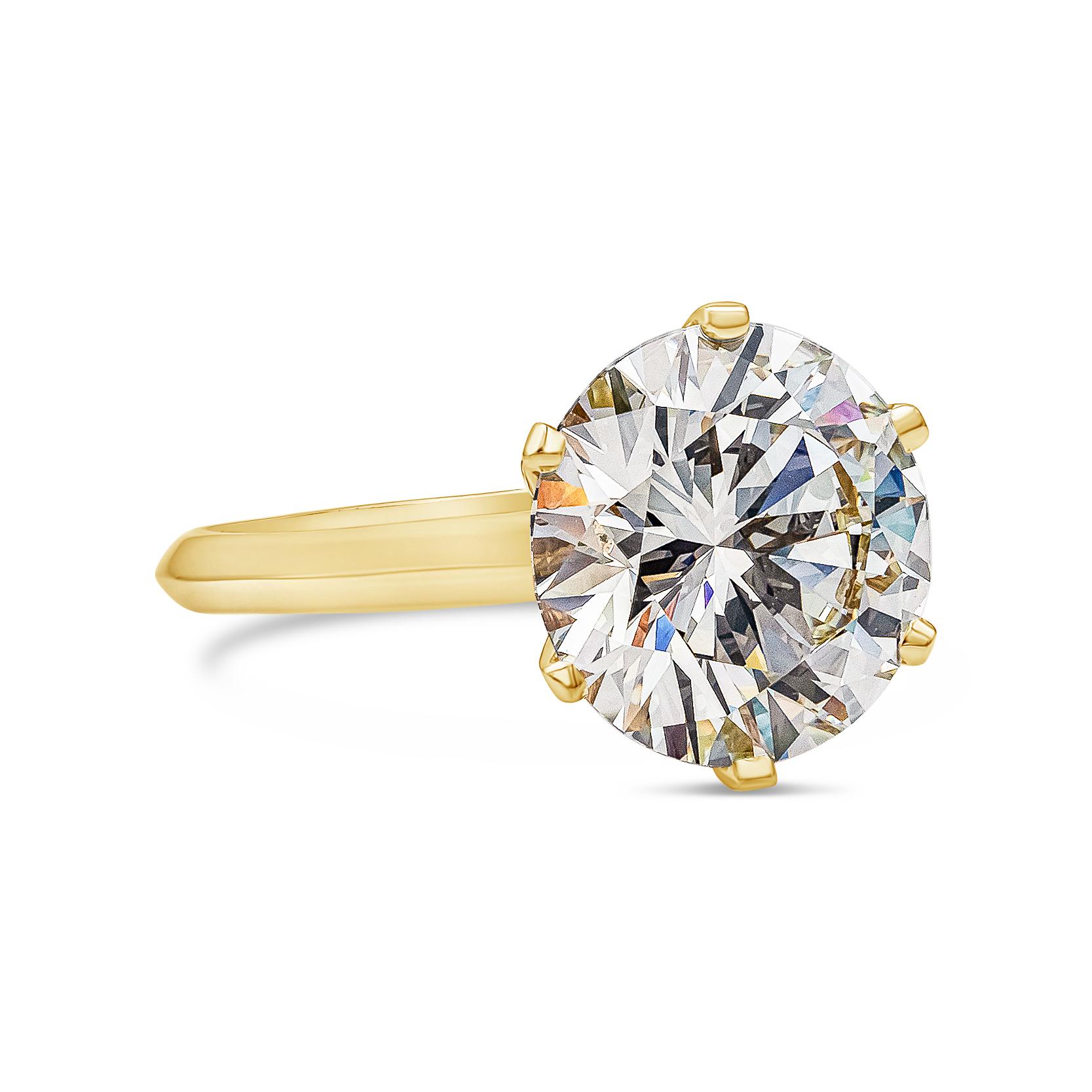 A classic engagement ring showcasing a 6.33 carat round brilliant diamond, set in a timeless six-prong solitaire style made in 18k yellow gold. Center diamond is certified by GIA as L color, IF clarity, Triple Excellent . Size 6 US. 

Style