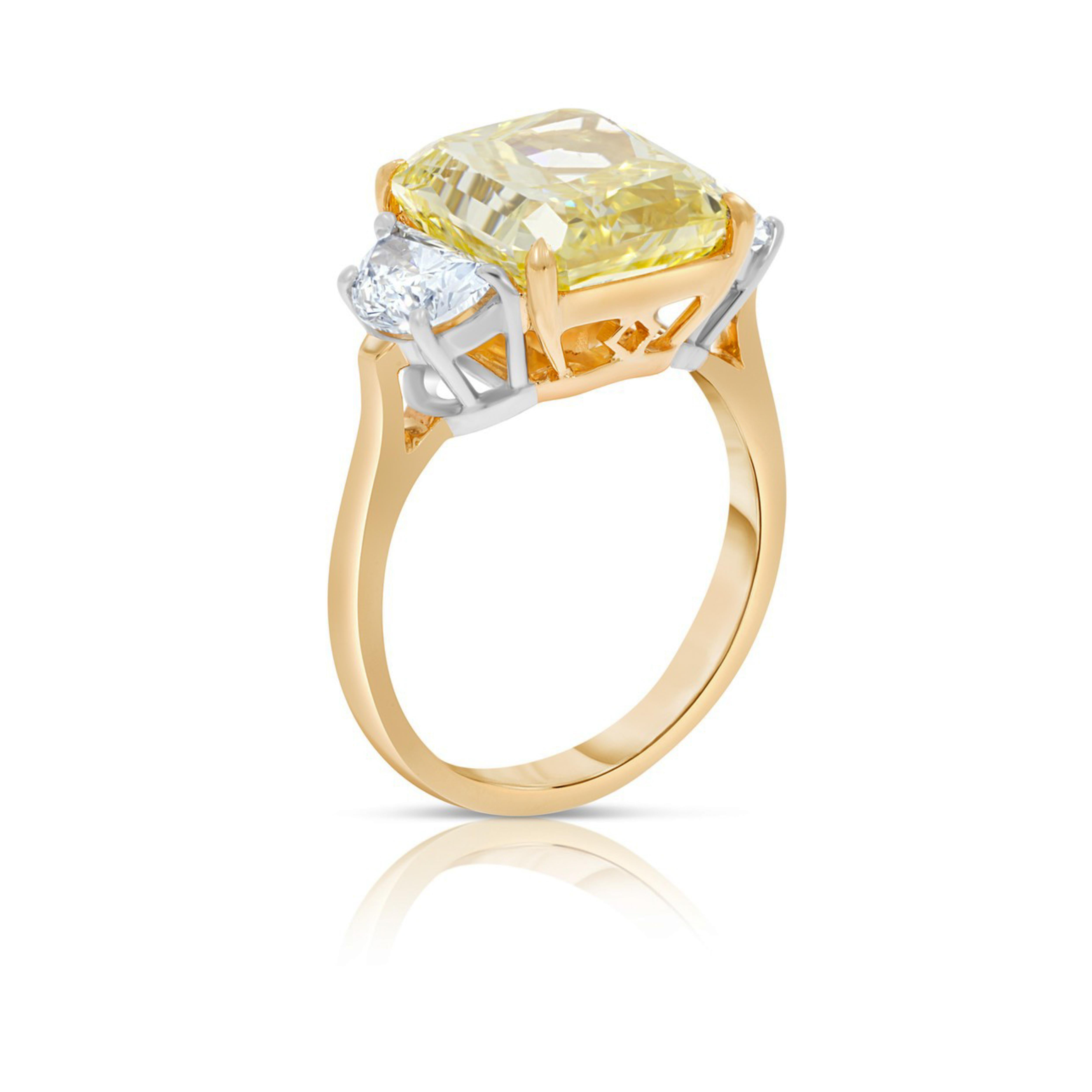 Platinum and 18K Yellow Gold Ring.  
Centering this gorgeous ring is a Radiant cut Fancy Intense Yellow Diamond, flanked by 1.30 carat total weight Half moon cut Diamond at each side.
Finger size: 6.5 +
GIA Certificate # 6197575388