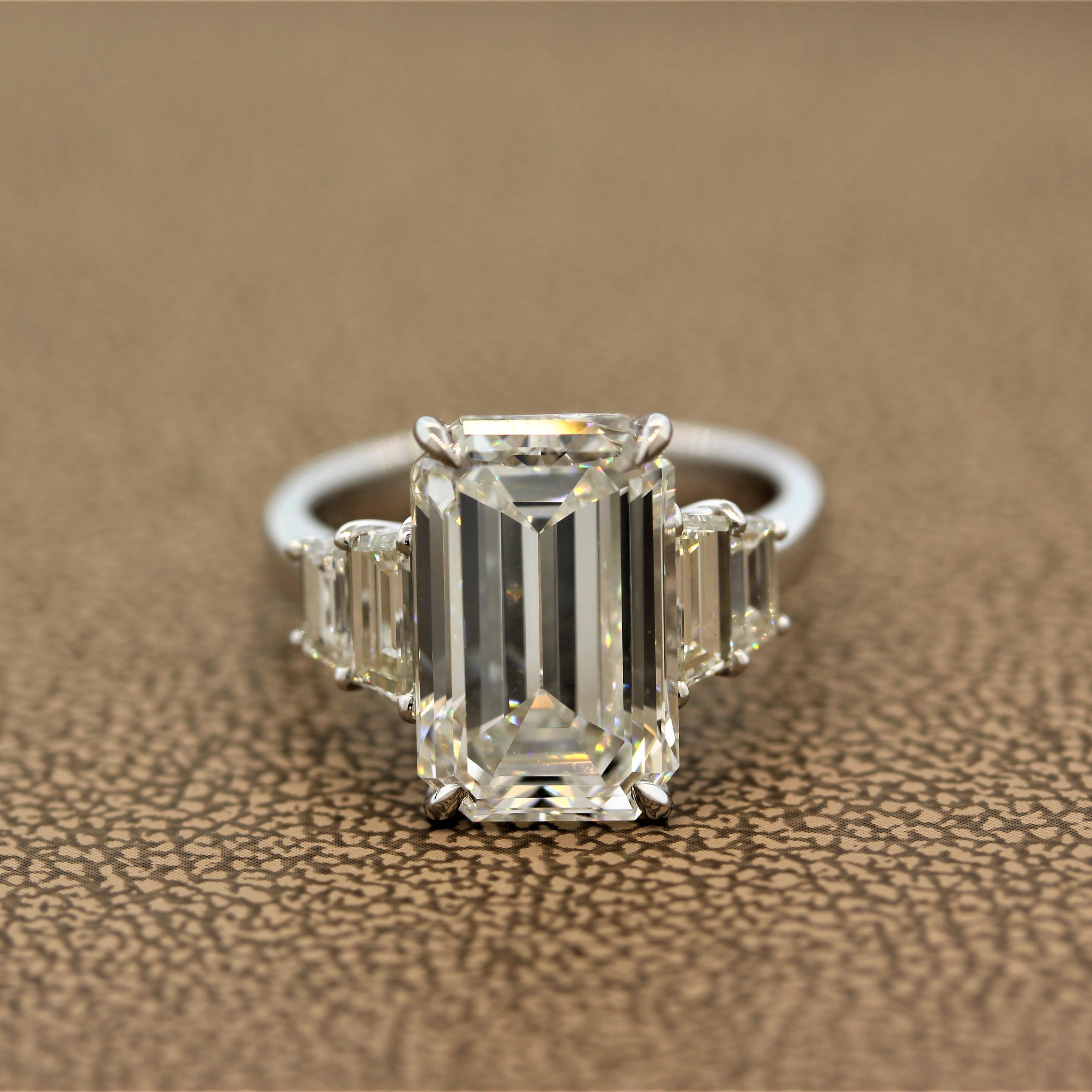 A chic and fashionable engagement ring featuring a 6.40 carat emerald cut diamond graded by the GIA as J color and VVS2 in clarity. We believe this rating to be harsh as in the faceup position this diamond looks 1-2 color grades better. Close to