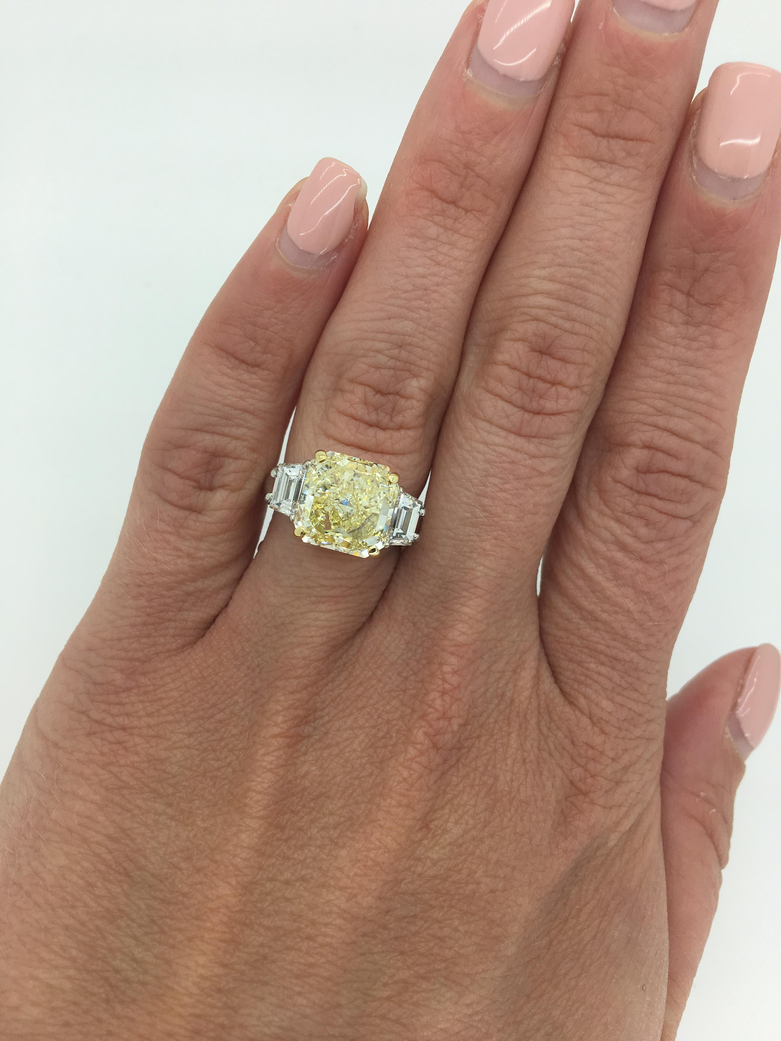 This beautiful ring features a GIA Certified 5.16CT Fancy Yellow Diamond, accented by two stunning Trapezoid Cut Diamonds.

GIA #11314484
Center Diamond Carat Weight: 5.16CT
Center Diamond Cut: Cut Cornered Square Modified Brilliant
Color: Fancy