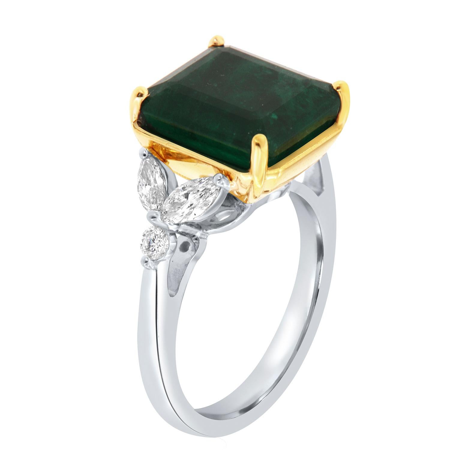 This stunning Platinum and 18k yellow gold ring feature a 6.53 Carat Emerald cut deep green Natural Emerald flanked by two (2) Marquees shape and one(1) Round shaped diamond on each side in a total weight of 0.58 Carat on a 2.4 mm wide band.
This