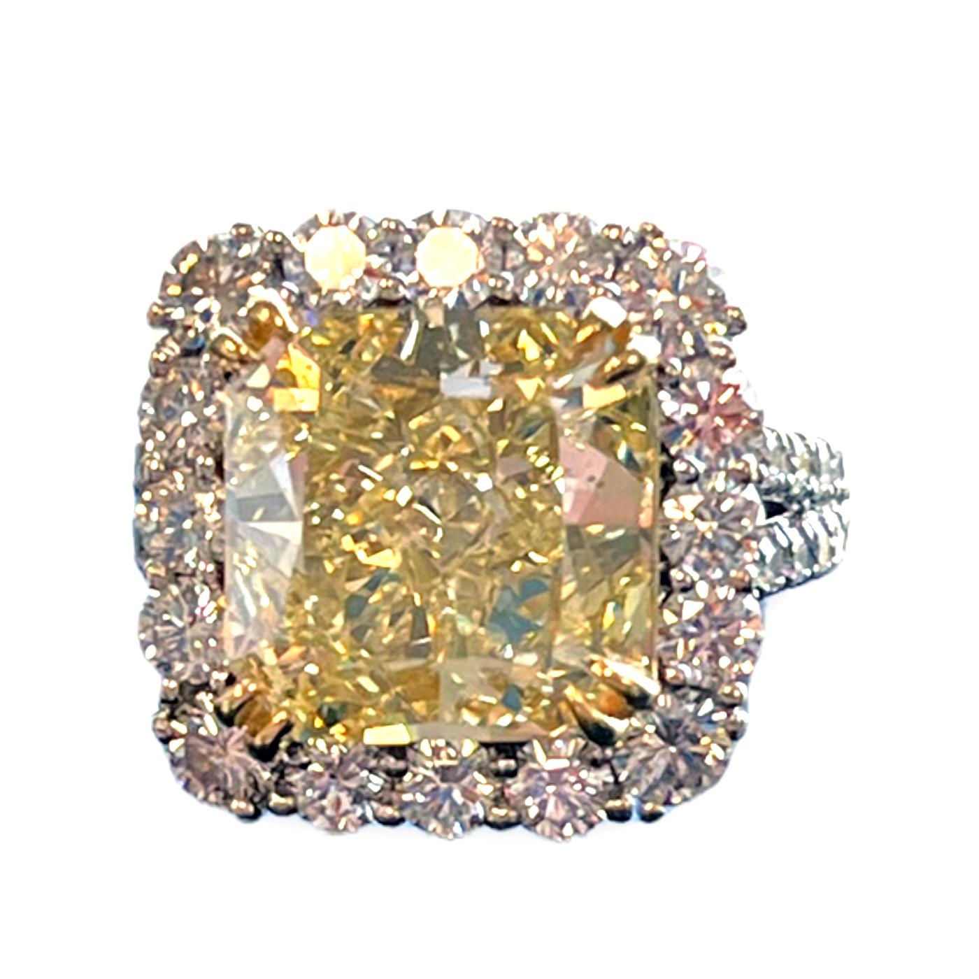 A GIA certificate accompanies 6.54-carat Cut-Cornered Fancy Light Yellow Si1 clarity. This spectacular Ring is full of brilliance and it is set in an 18-karat white gold setting.  Setting features exceptional to pave work, Delicate yet sturdy,