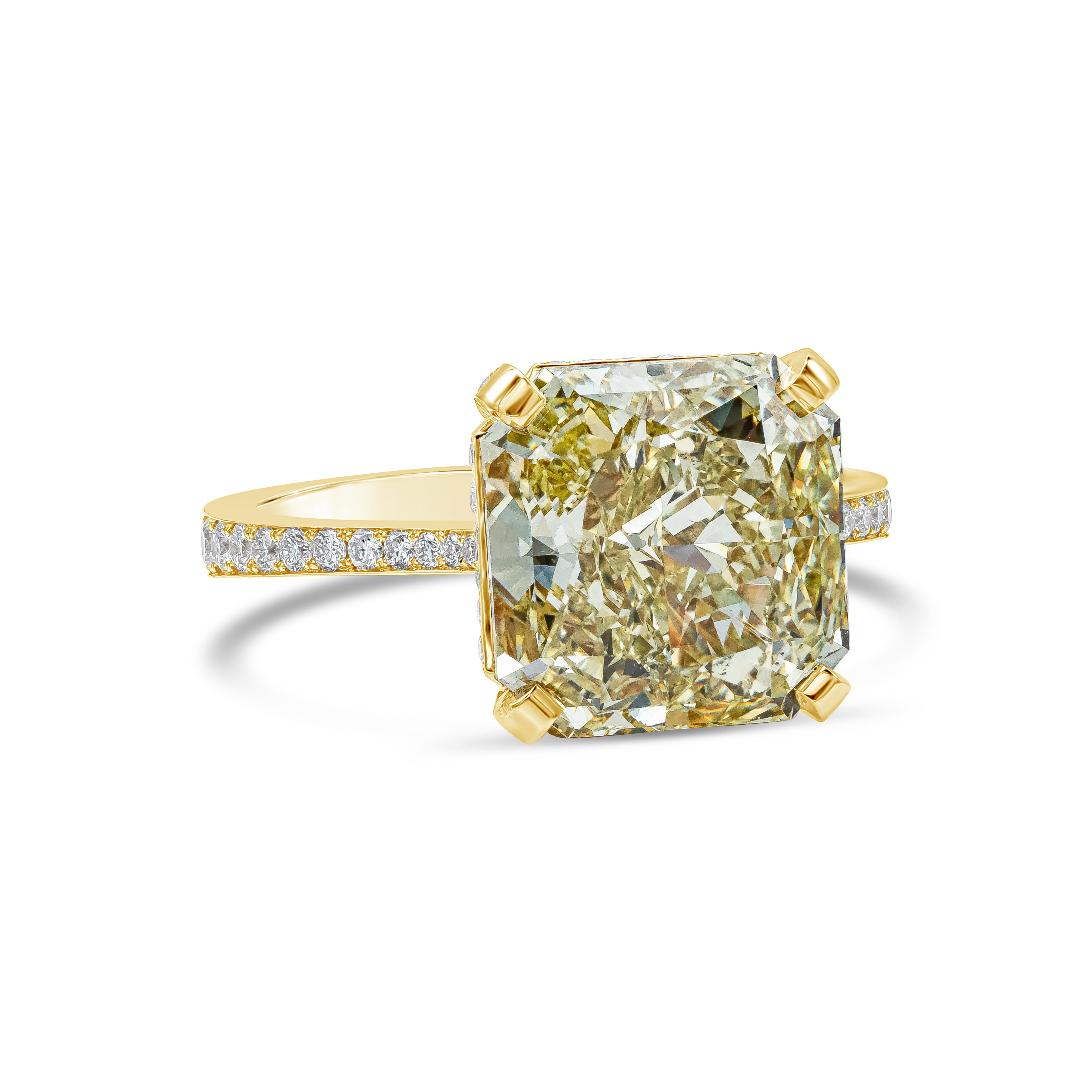 A classic and color-rich pave engagement ring showcasing a vibrant GIA certified 6.54 carat radiant cut fancy yellow diamond, VS2 in clarity, set in a four prong 18k yellow gold basket. Accented by 88 pieces of brilliant round diamonds from gallery
