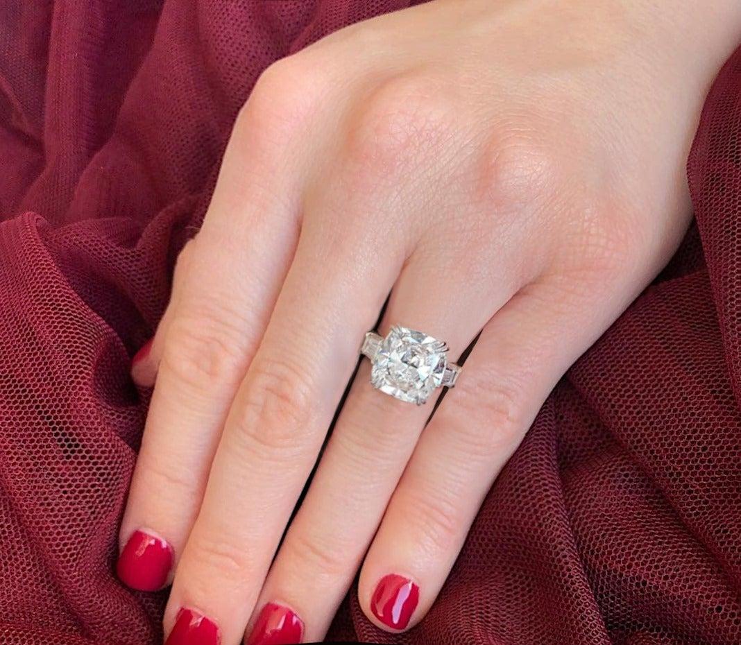 GIA certified 7 ct cushion cut diamond, boasting an G color grade and VS1 clarity, set upon an platinum band. This centerpiece gem embodies elegance and brilliance, characterized by the cushion cut's brilliant facets, which accentuate its inherent