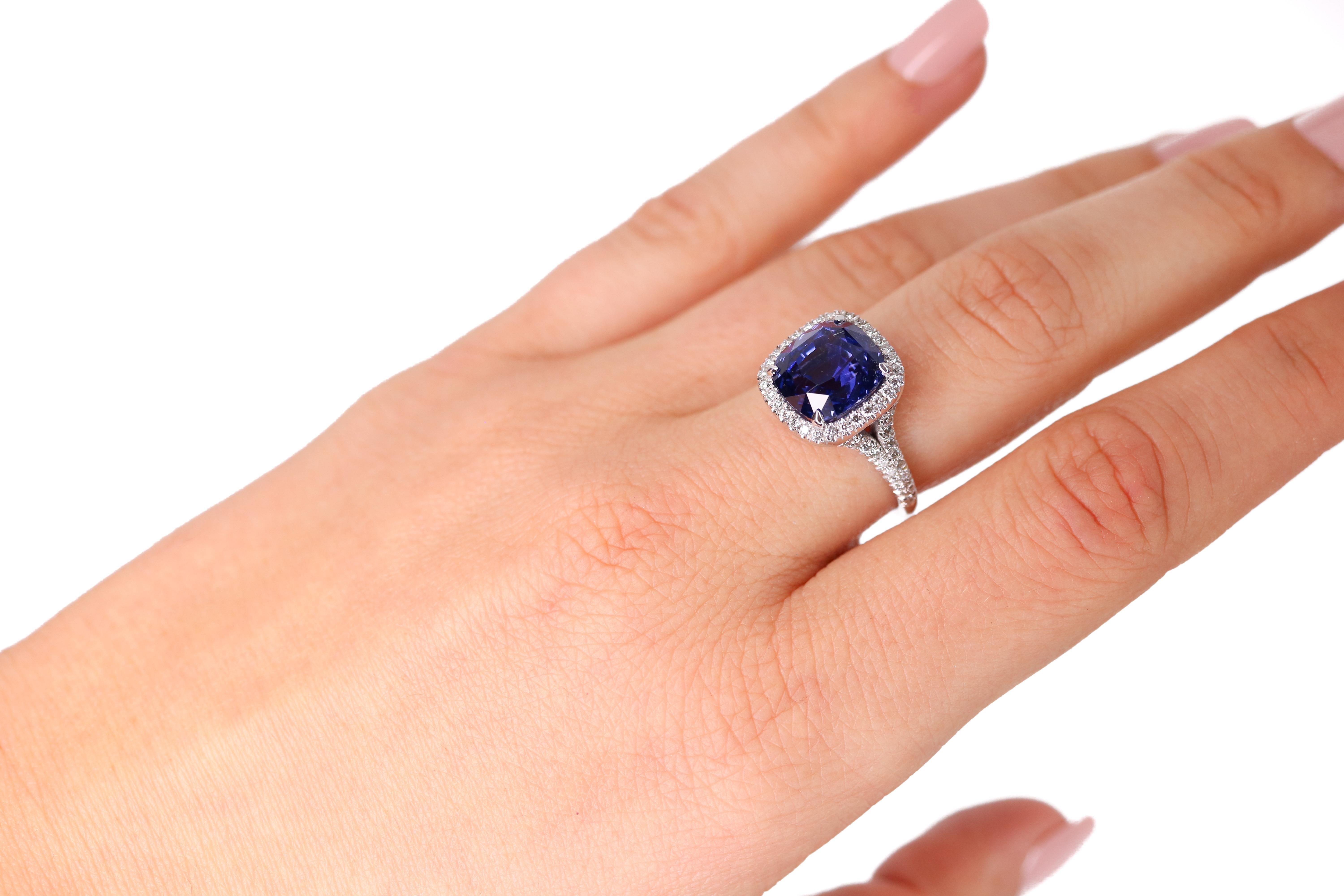 This 6.56ct Cushion Violet Blue Sapphire Gem is set in a Platinum ring with a halo of 0.46 carat total weight diamonds.

This Sapphire is GIA certified #2173186881