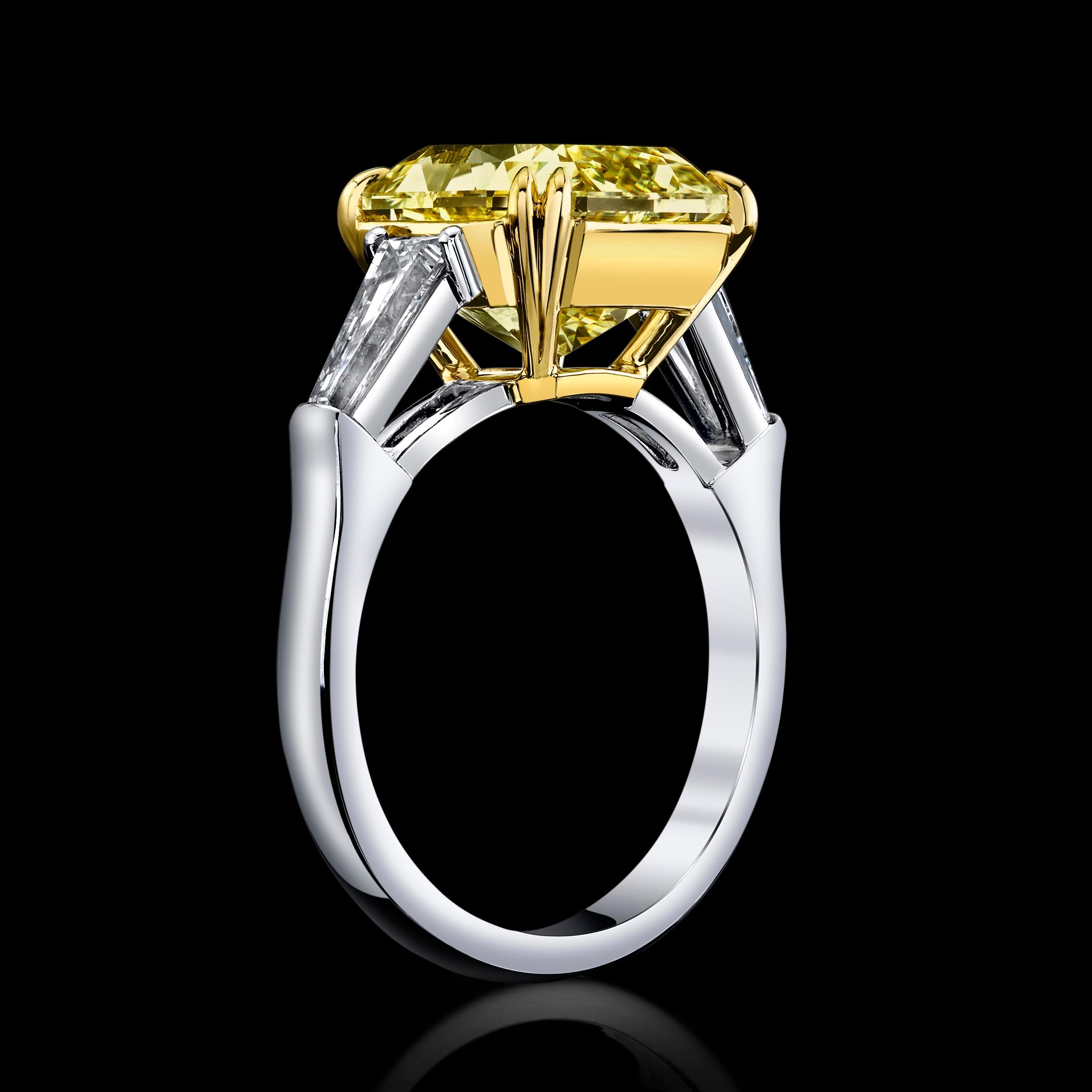 Brighten your day with this exquisite 5.07ct Radiant Fancy Yellow, SI2 Natural Diamond set in a Platinum & 18K Yellow Gold Ring flanked by 2 shimmering Baguette Diamonds=0.65cttw

This Diamond is GIA certified.