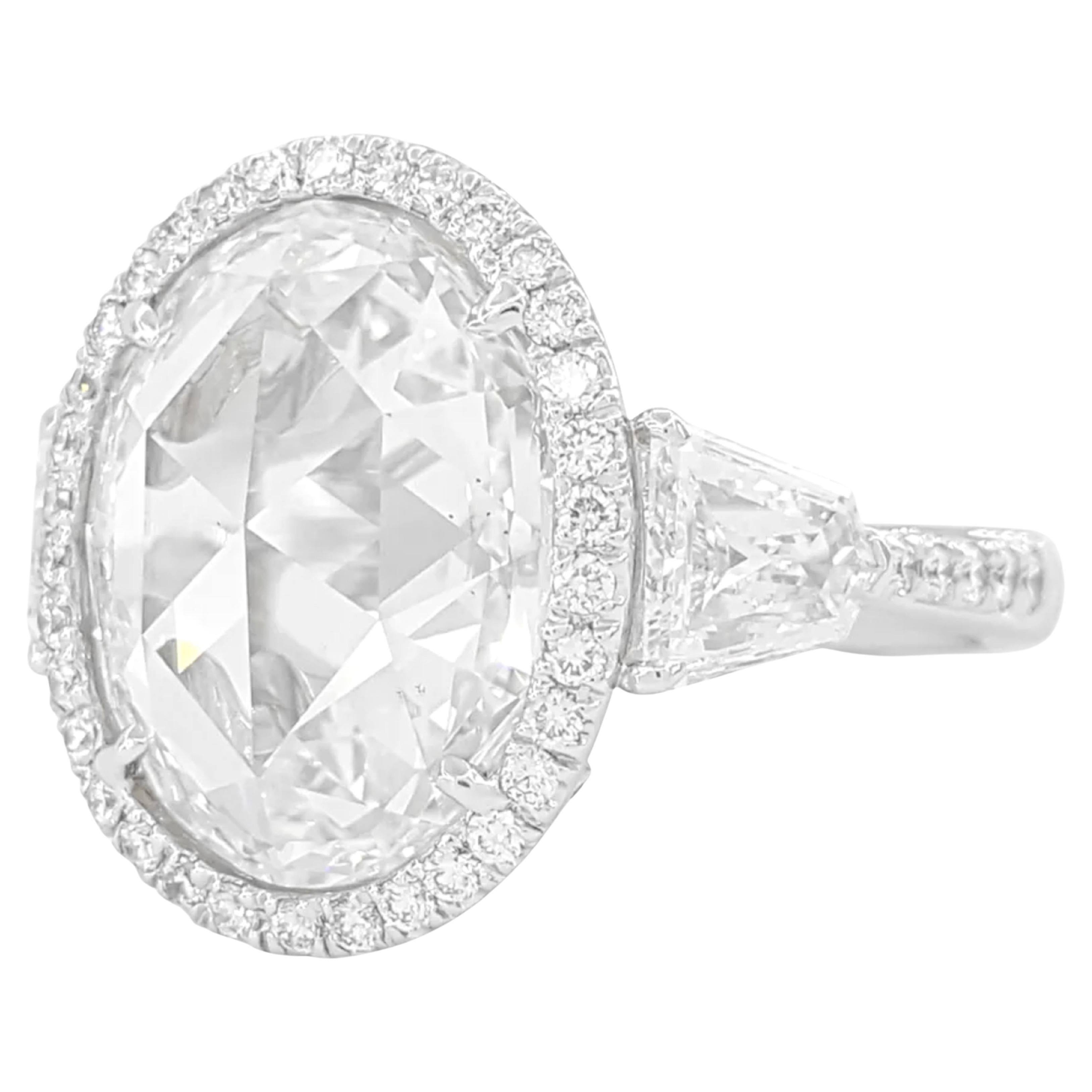 6.64 ct Total Weight Oval Rose Cut & Shield Cut Diamond Three-Stone Engagement Ring in Platinum is an elegant and striking piece. The ring weighs 8.6 grams and is size 7. 

At the center, it features a stunning natural 5.18 ct Oval Rose Cut Diamond,