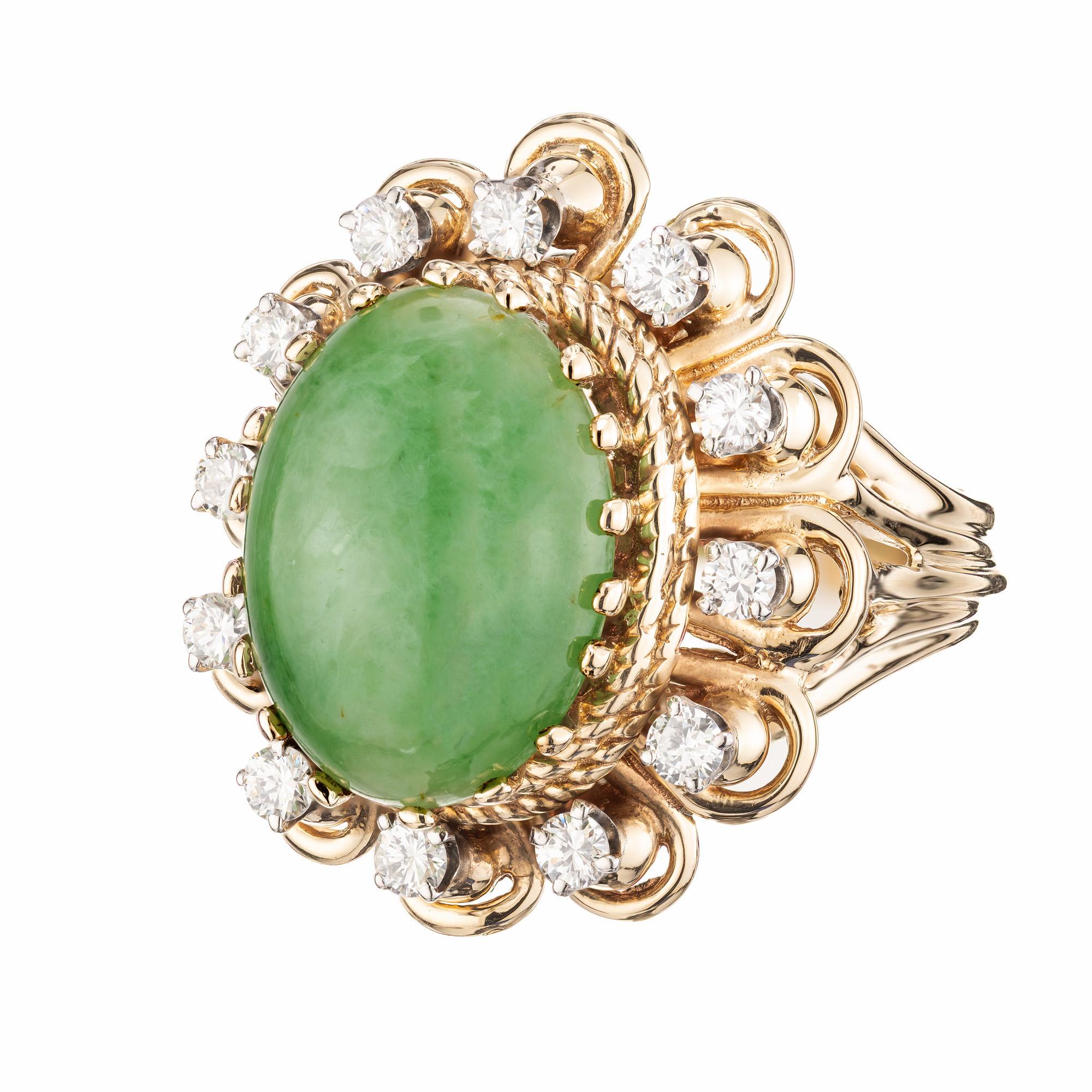 A beautifully crafted jadeite jade and diamond fashion ring. Dated from around the 1950’s this ring is 14k yellow gold with a 6.7 carat center jade oval that is GIA certified encircled by 12 round brilliant cut diamonds. The design showcases a blend