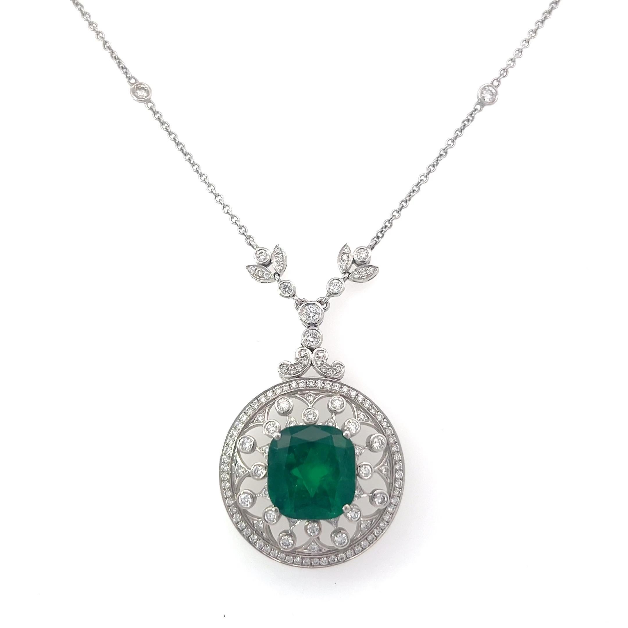 Crafted in 18k white gold and GIA certified, this is a one of a kind emerald and diamond necklace. Featuring a 6.88 carat cushion cut emerald, enhanced with Excel, the only enhancement guaranteed for a lifetime. Set in a floral inspired handmade