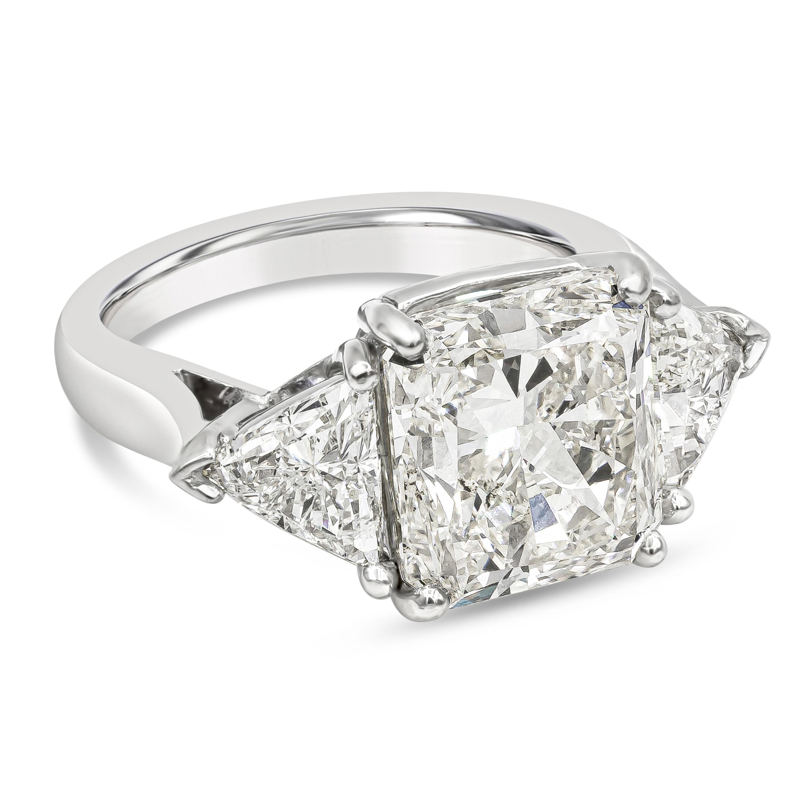 Elegantly made three stone engagement ring features a 6.90 carats radiant cut diamond certified by GIA as L color, SI1 in clarity, set in platinum four prong setting. Flanked by brilliant trillion cut diamonds on either side, weighing 1.50 carats