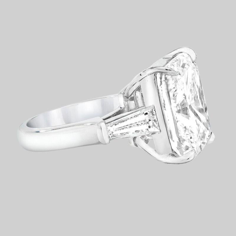 This exquisite 18k white gold ring presents a breathtaking centerpiece: a 7 carat GIA certified Cushion briliant diamond. 

The diamond boasts a remarkable D color and VVS2 clarity, ensuring a dazzling display of brilliance and clarity. Expertly cut