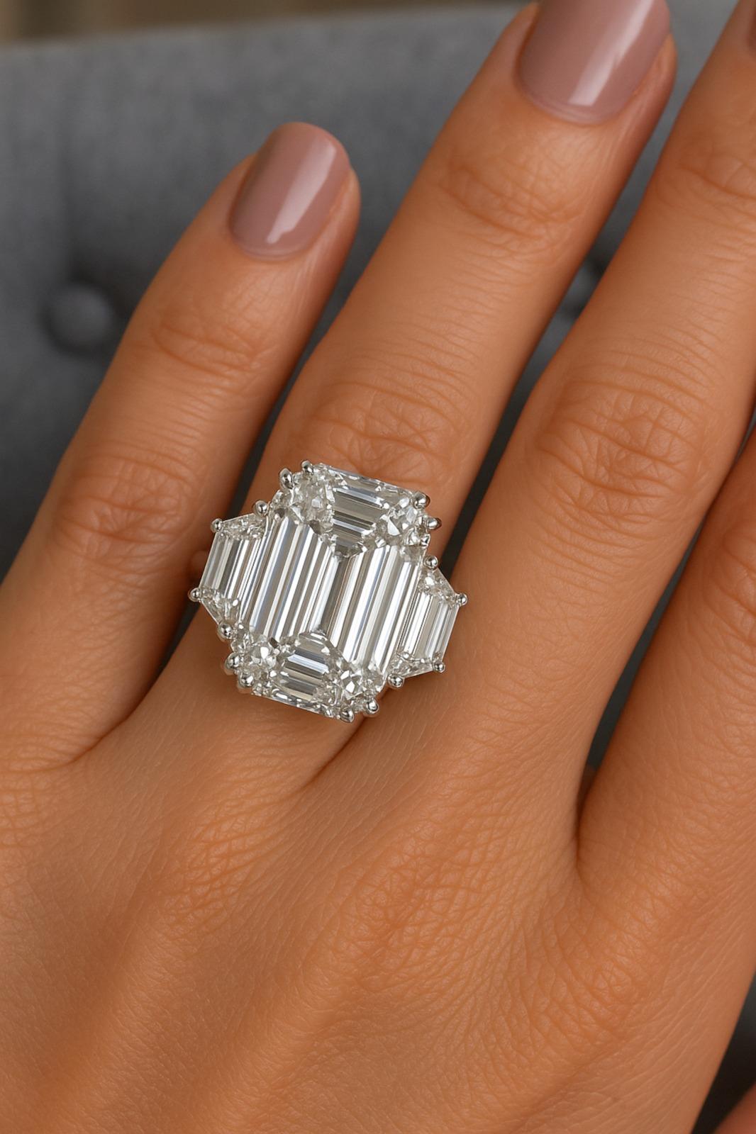 This exquisite ring boasts a magnificent 7 carat emerald-cut diamond as its centerpiece, certified by the Gemological Institute of America (GIA) to ensure its exceptional quality and authenticity. The diamond dazzles with a rare F color grade,