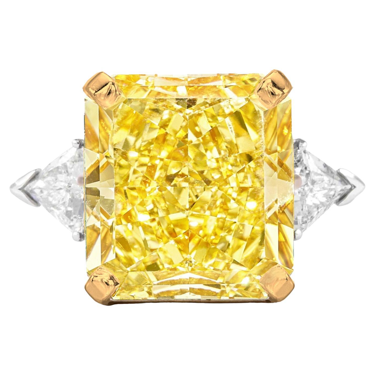 Introducing the mesmerizing GIA Certified 7.01 Carat Radiant Cut Fancy Yellow Diamond Ring, a true testament to luxury and elegance. This exquisite ring features a stunning radiant-cut diamond, certified by the esteemed Gemological Institute of