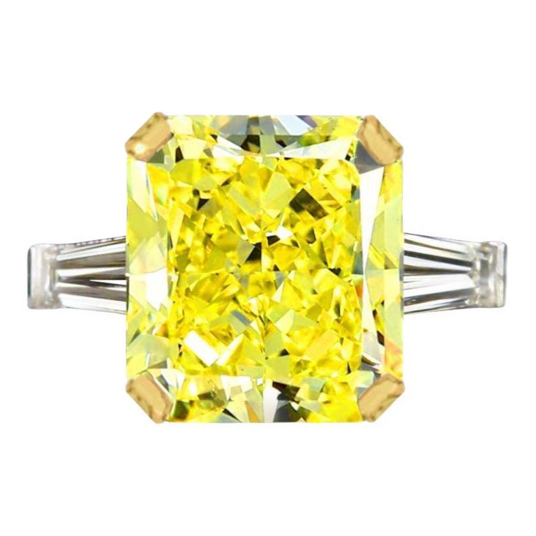 GIA Certified 7 Carat Radiant Cut Fancy Yellow Diamond with tapered baguette For Sale
