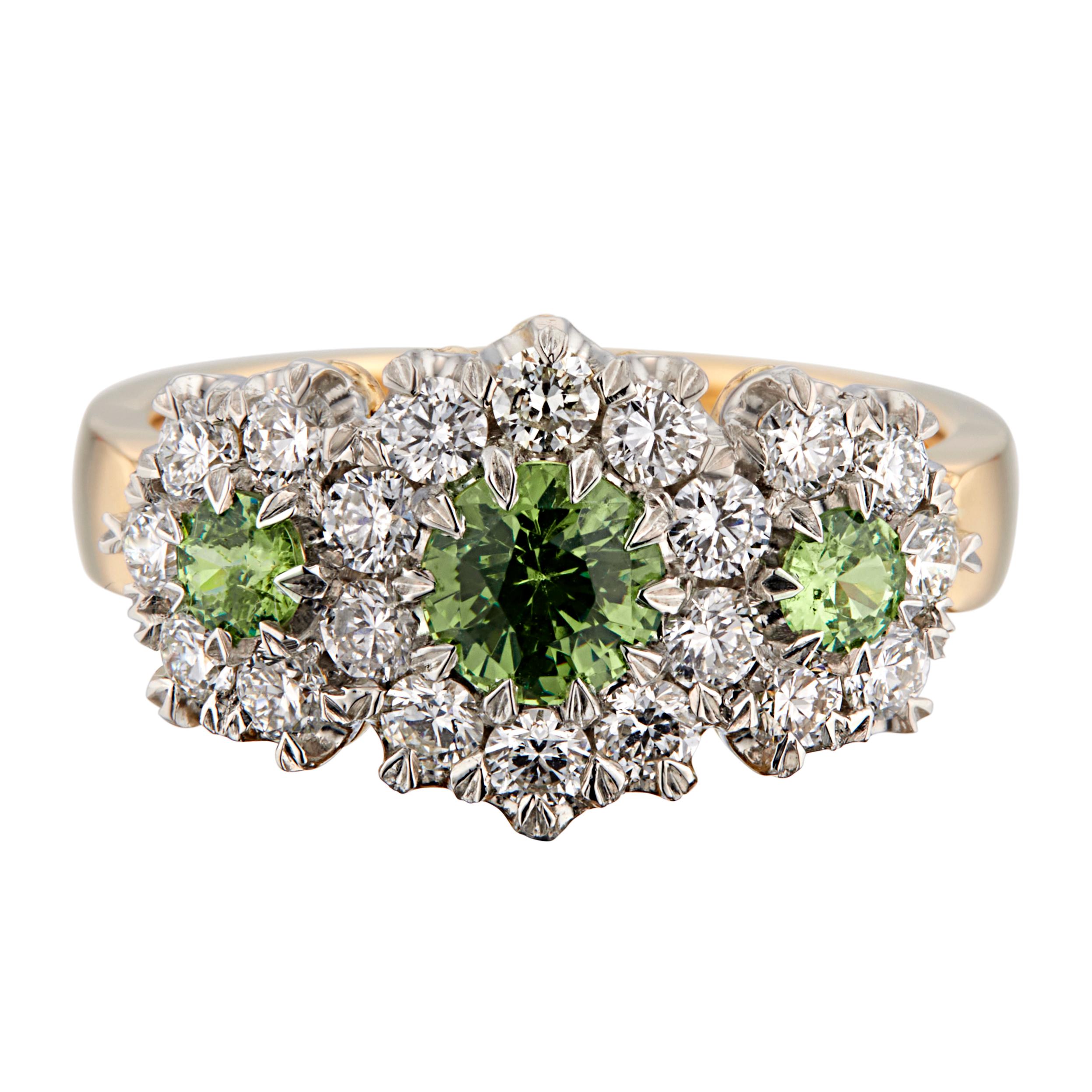 Green garnet and diamond engagement ring. .70cts green garnet with 2 round demantoid green accent garnets, each with a halo of round brilliant cut diamonds in a platinum top and 18k yellow gold shank. 

1 demantoid green garnet, approx. .70 carats