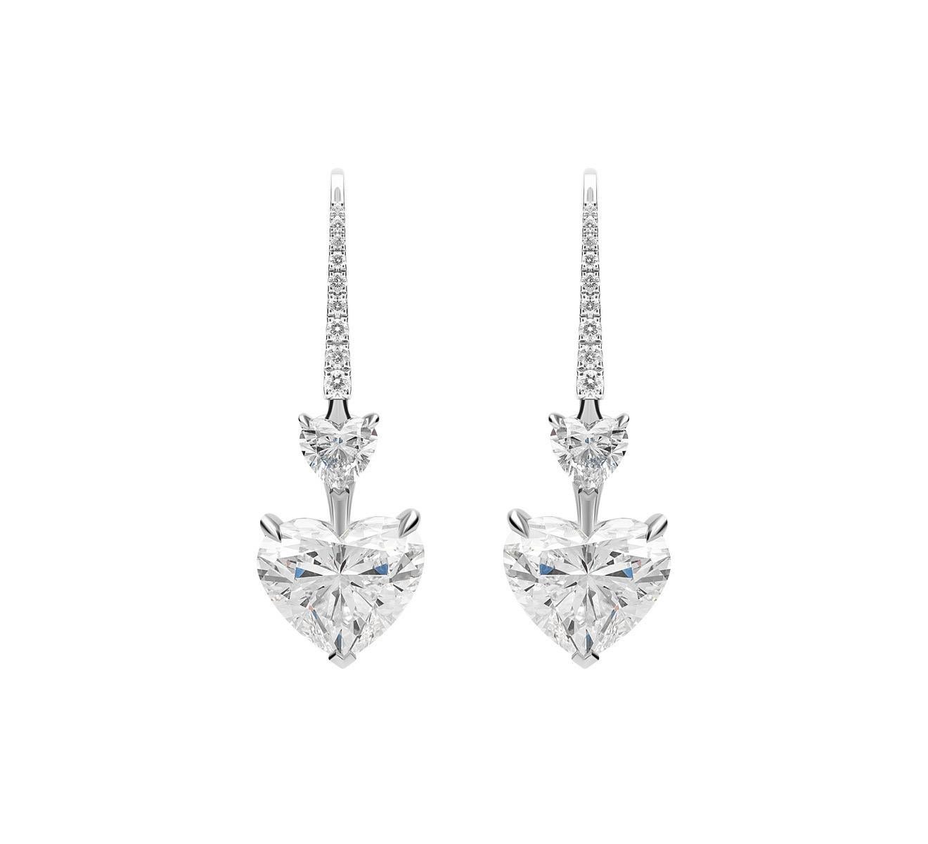 Heart Shape Diamonds each weighing 3.0 carat, suspended from Heart shape Diamonds each weighing 0.50 Carats and embellished with Round Diamonds weighing 0.30 Carats.
Heart shape Diamonds graded as H-I color and SI clarity.
Set in Platinum.
