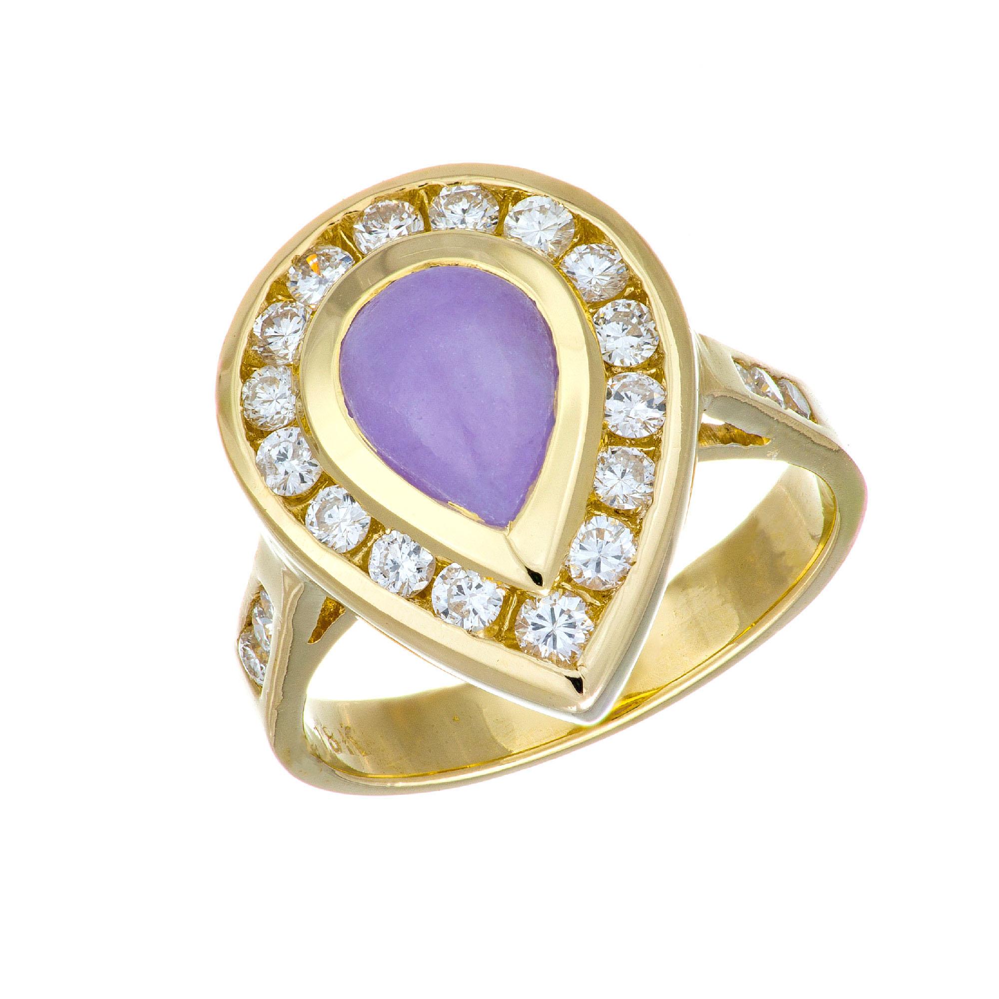Purple Jadeite Jade in a custom-made pear shape ring. GIA certified pear shaped cabochon Jadeite Jade center stone with a halo of full cut diamonds in a 18k yellow gold setting with diamonds along the shank. 

1 pear shaped cabochon purple Jadeite