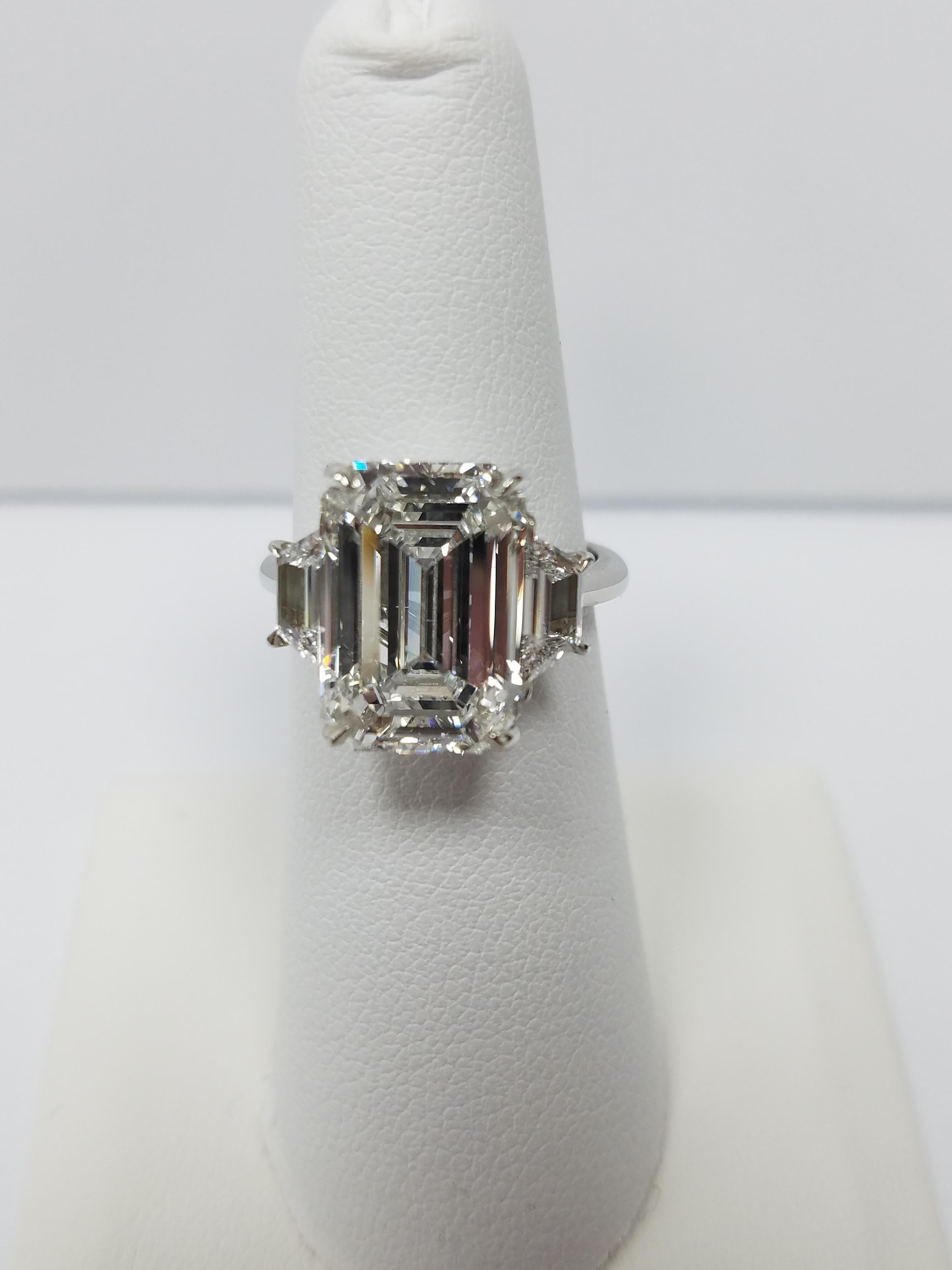 GIA Certified 7.01 carats Emeralds Cut Ring F color and  VS2 quality center stone. Mounted in a platinum setting with 2  trapezoid  diamonds (1 on each side) also F color and VS2 quality. GIA certificate # 2193114231