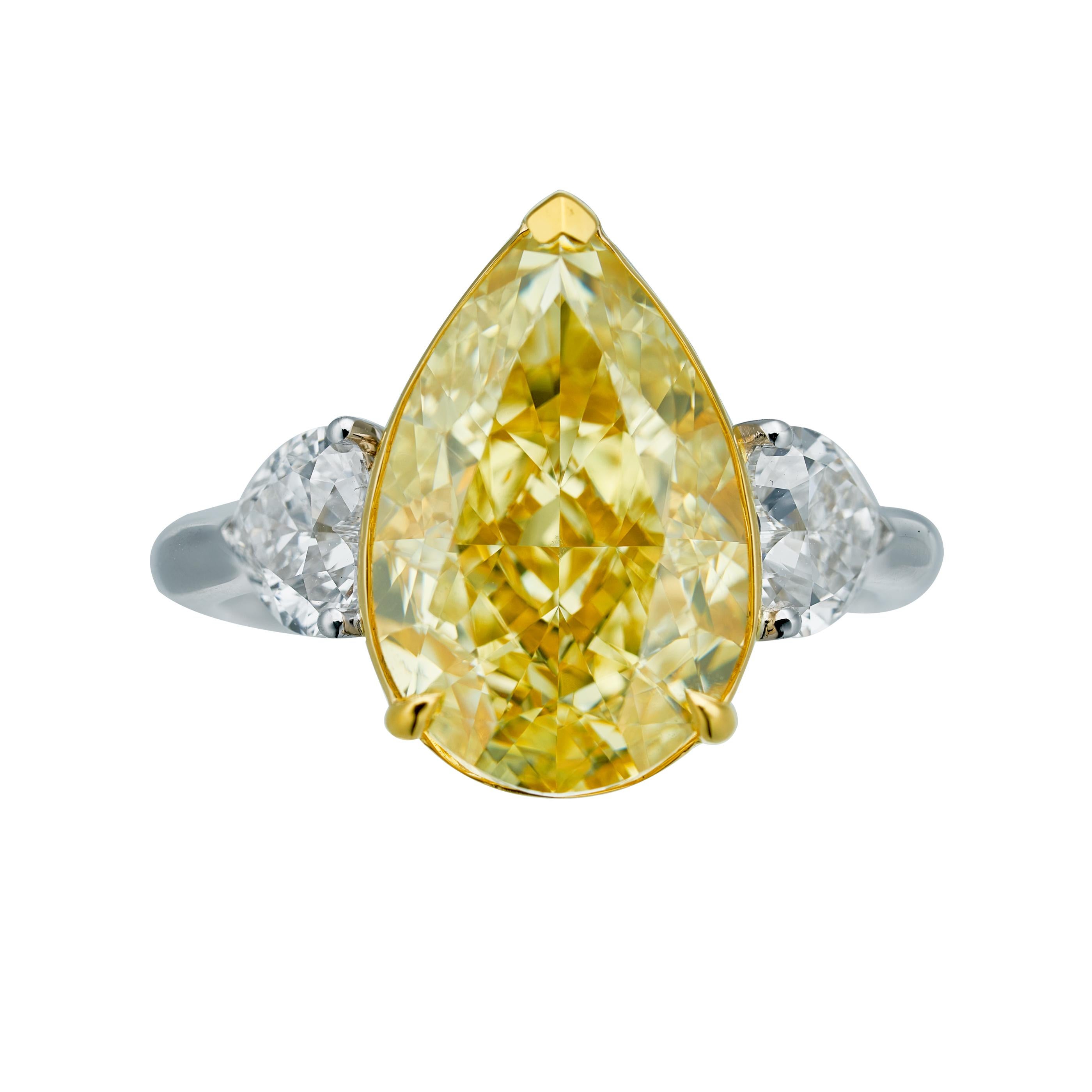 7.02ct Natural Fancy Yellow GIA Certified Pear Shape Diamond Ring, a radiant masterpiece destined to captivate hearts and illuminate any occasion. This extraordinary ring is crafted in lustrous 18kt gold, showcasing a centerpiece of remarkable