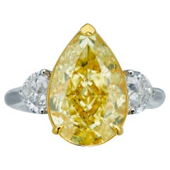 GIA Certified, 7.02ct Natural Fancy Yellow Pear Shape Diamond Ring in 18KT 