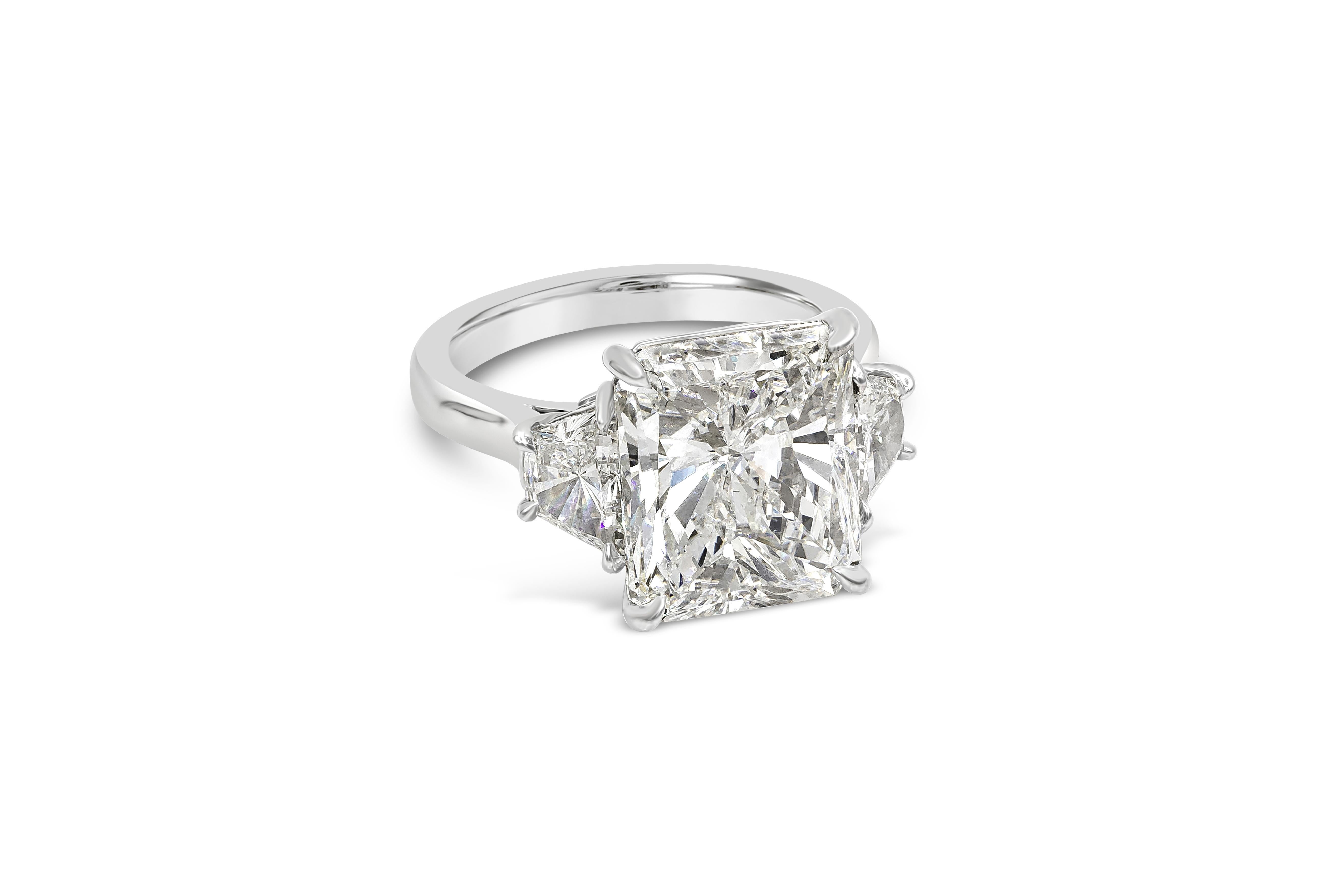 A classic three-stone engagement ring style perfect for anyone. Showcases a 7.03 carat brilliant radiant cut diamond certified by GIA as H color, SI1 clarity, accented by brilliant trapezoid diamonds on either side. Accent diamonds weigh 1.28 carats