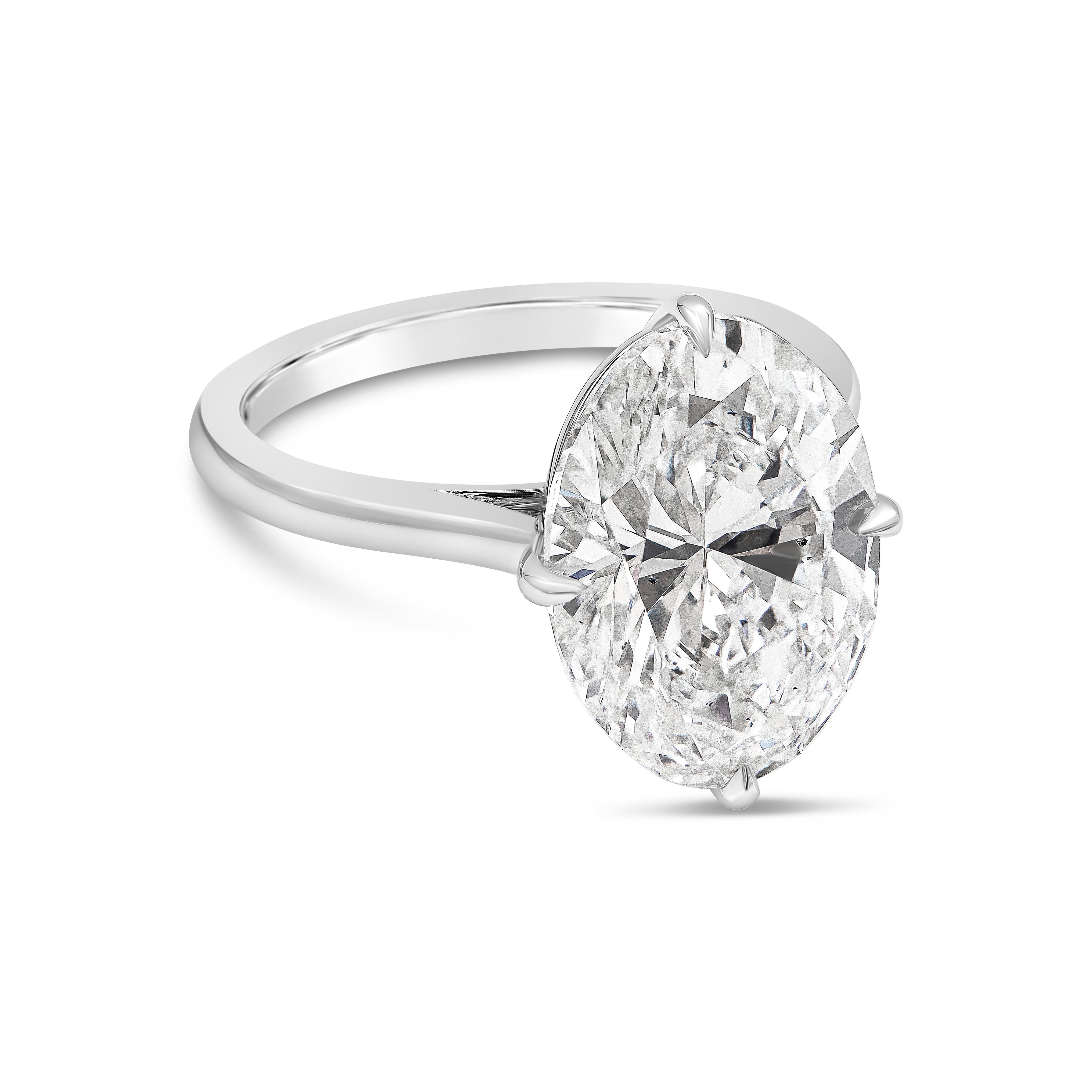 A timeless engagement ring, showcasing a 7.04 carats oval brilliant cut diamond certified by GIA as F color and SI1 clarity, set in a unique compass setting. Finely made with a platinum mounting. Size 6 US, resizable upon request. 

Roman Malakov is