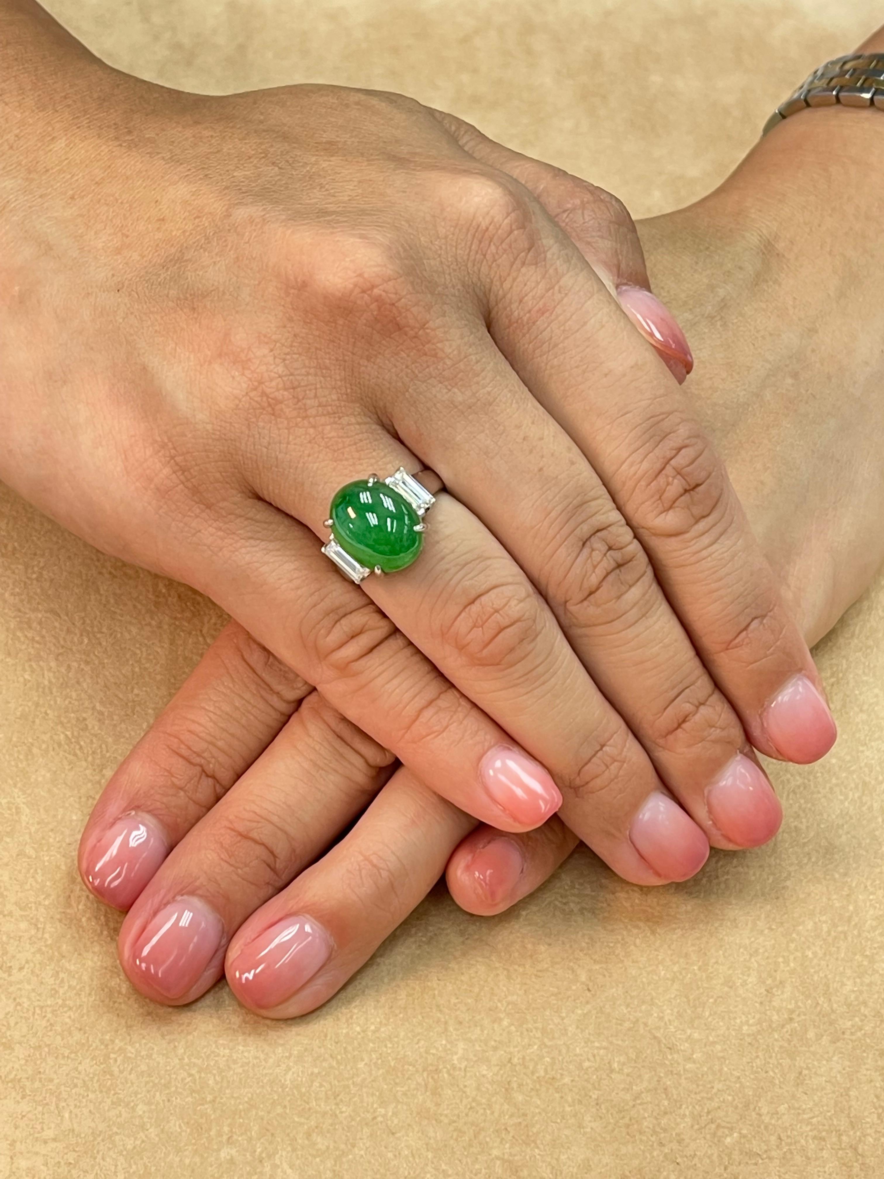 PLEASE CHECK OUT THE HD VIDEO! This jade is light apple green in color. It is a larger natural jade at just over 7 cts with a nice dome and not backed to show the true color. This is a simple 3 stone ring with a twist. On each side of the jade is a