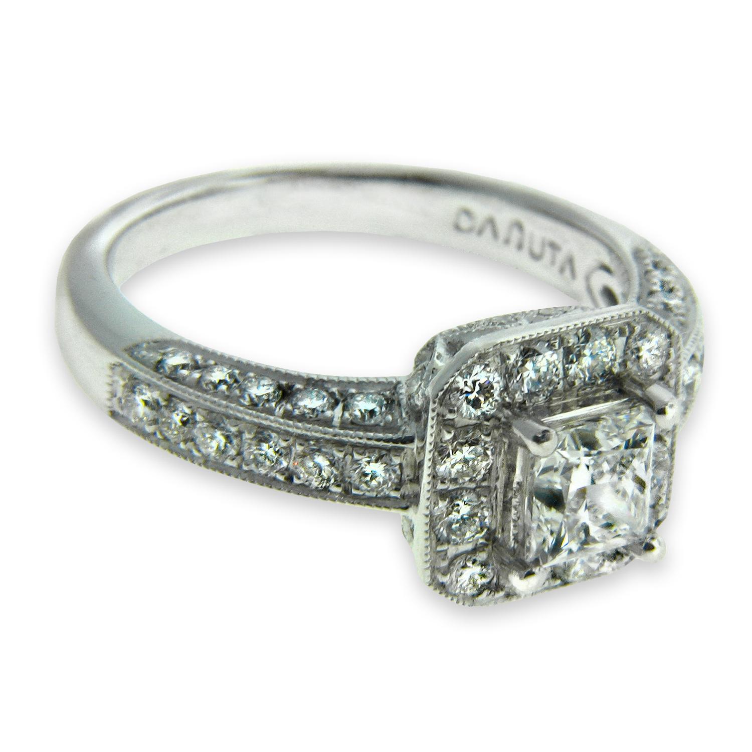 This ring is the epitome of classic design, thoughtful created by world renowned jewelry designer Danuta. The focal point is the GIA certified .71 carat Princess Cut Diamond E/VS1 color/clarity. This princess cut diamond easily conveys a high degree