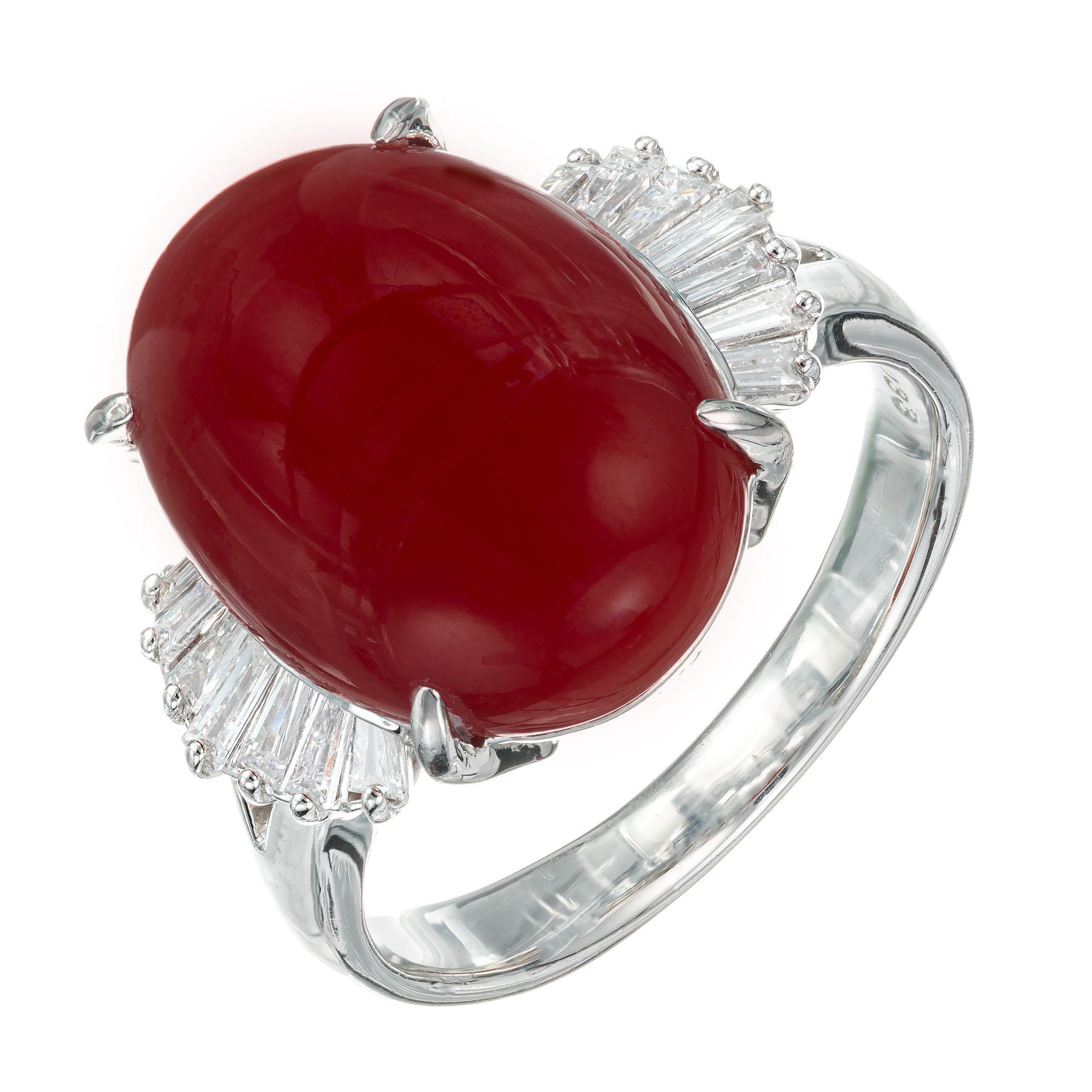 Coral and diamond ring. GIA Certified natural, untreated oval cabochon coral center stone. Set in platinum with 14 tapered baguette accent diamonds.  

1 oval orangey red cabochon coral, approx. 7.11cts GIA Certificate # 5212597558
14 tapered