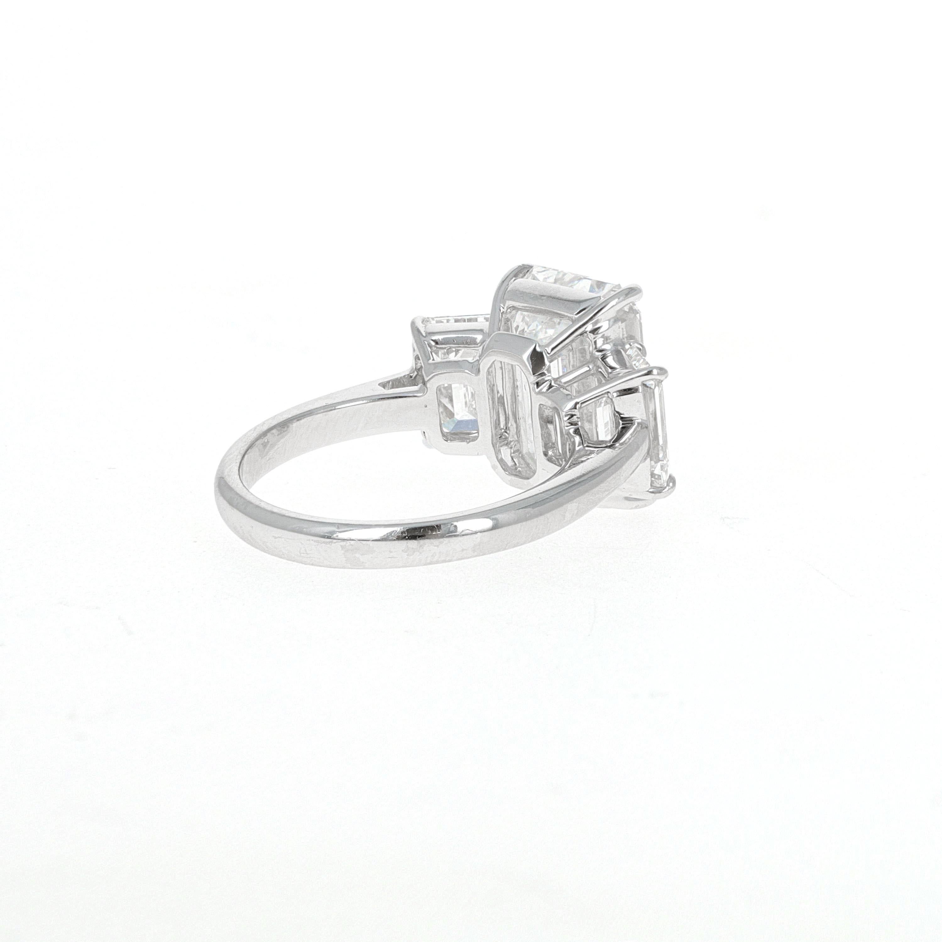 Modern GIA Certified, 7.14 Carat Three-Stone Emerald Cut Diamond Ring