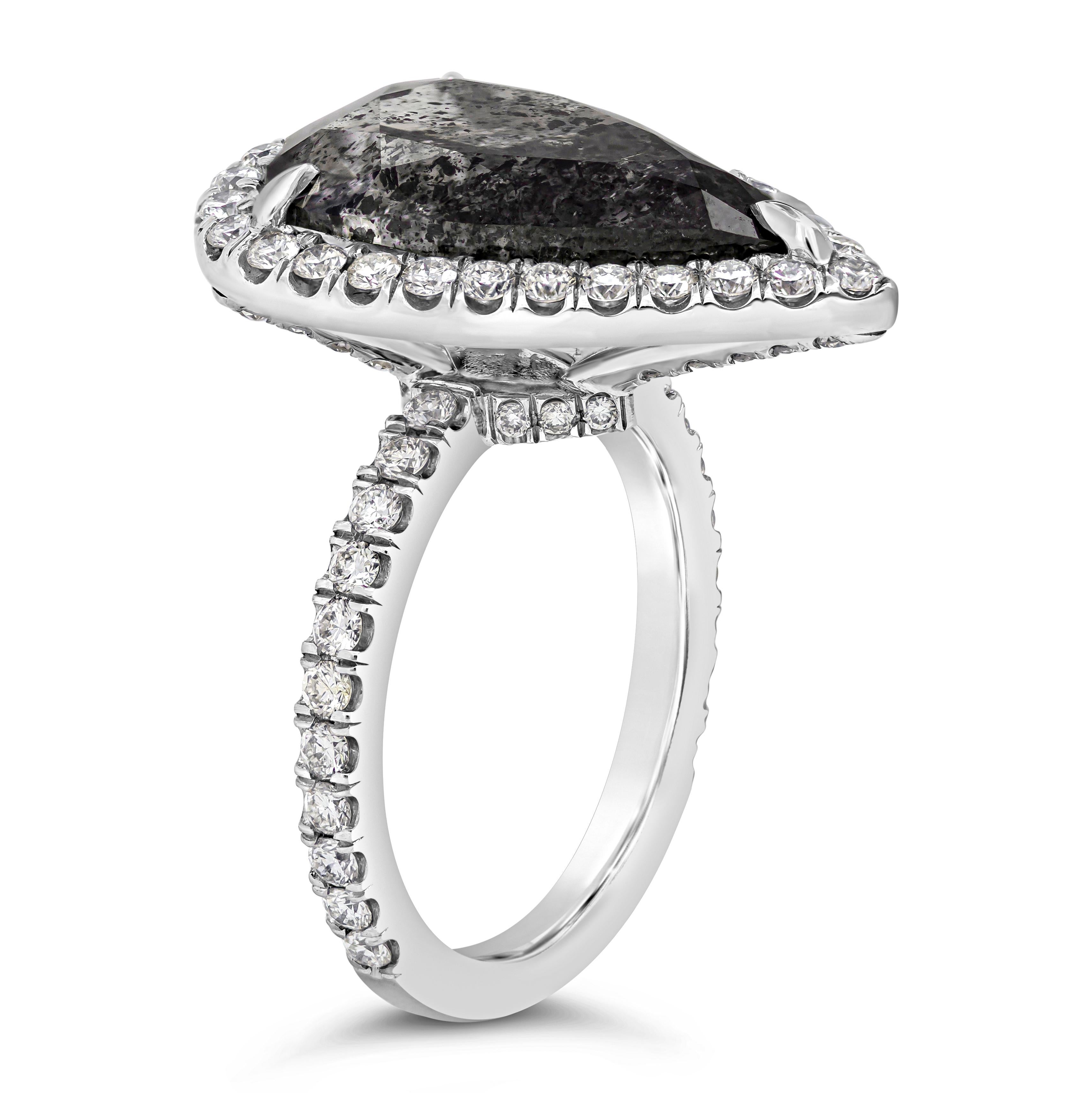 This simple but fashionable engagement ring showcasing a 7.19 carats pear shape diamond that GIA certified as Fancy Dark Gray color (natural black diamond). Surrounding the center diamond is a row of sparkling round diamonds in an elegant halo