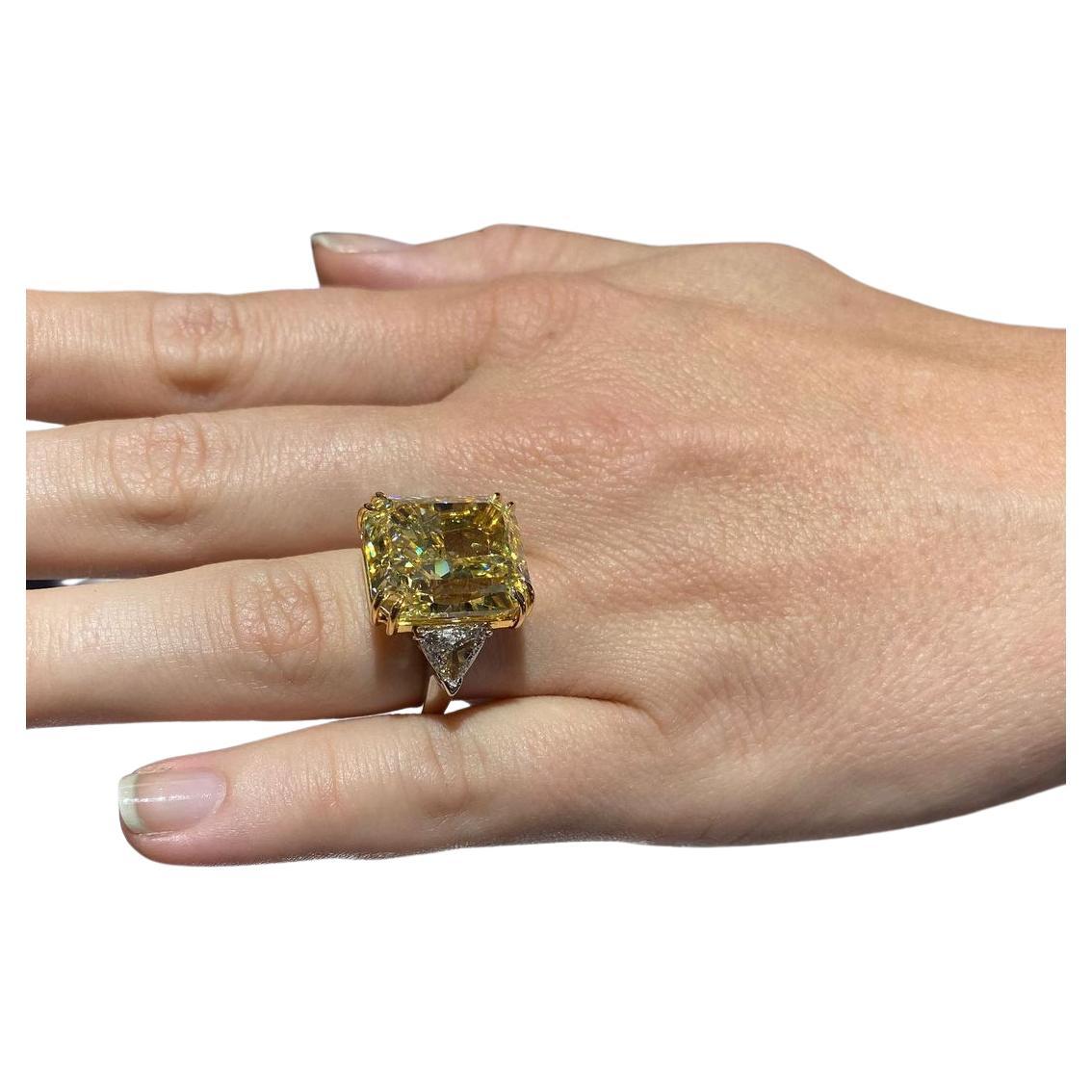 An exquisite 7.20 carat radiant cut fancy yellow diamond ring set with two tapered baguette diamonds 

