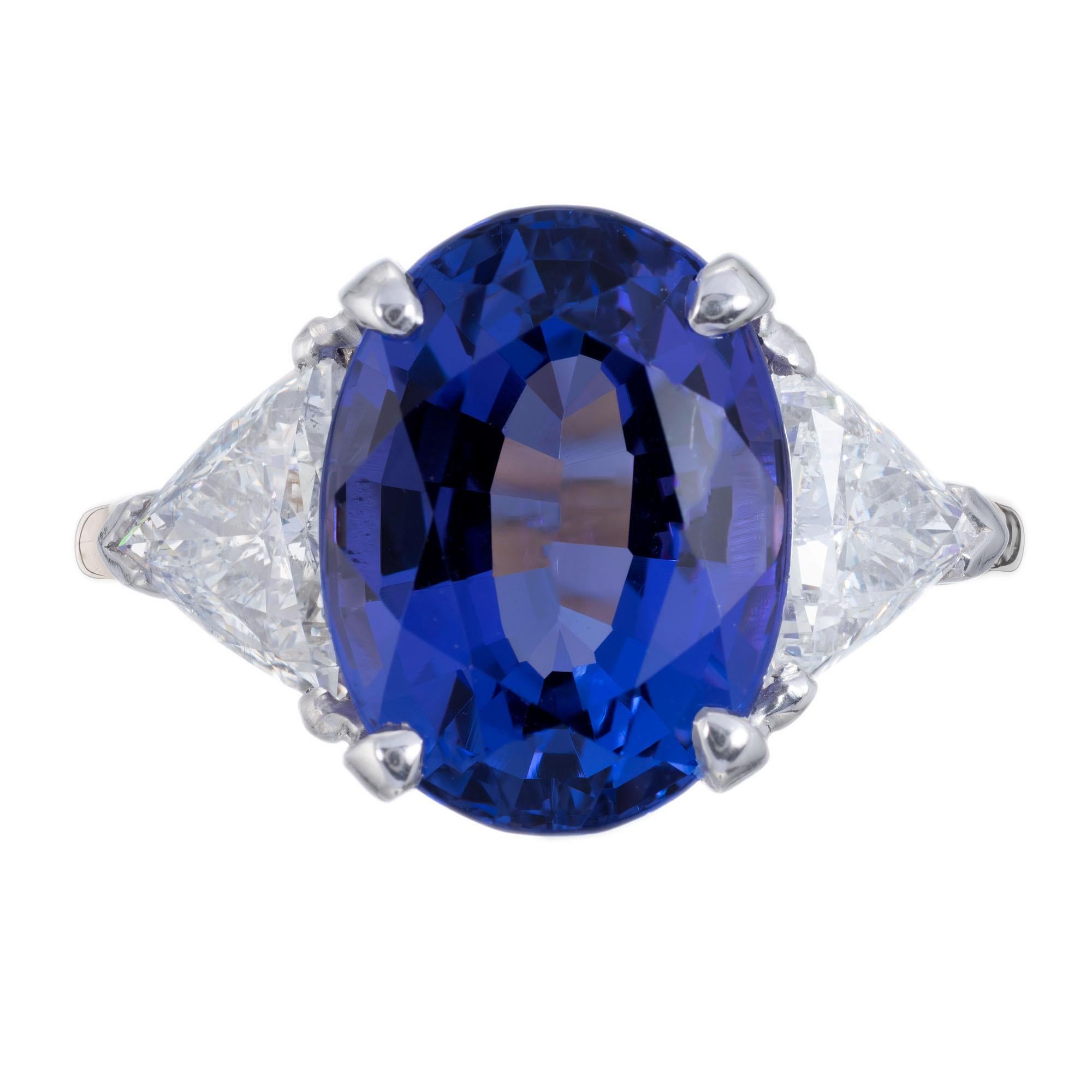 Blue violet 7.22 carat oval tanzanite and diamond engagement ring. GIA certified oval center stone with two trilliant cut side diamonds in an 18k yellow gold setting with a platinum top.

1 oval bluish violet tanzanite, approx. 7.22cts GIA