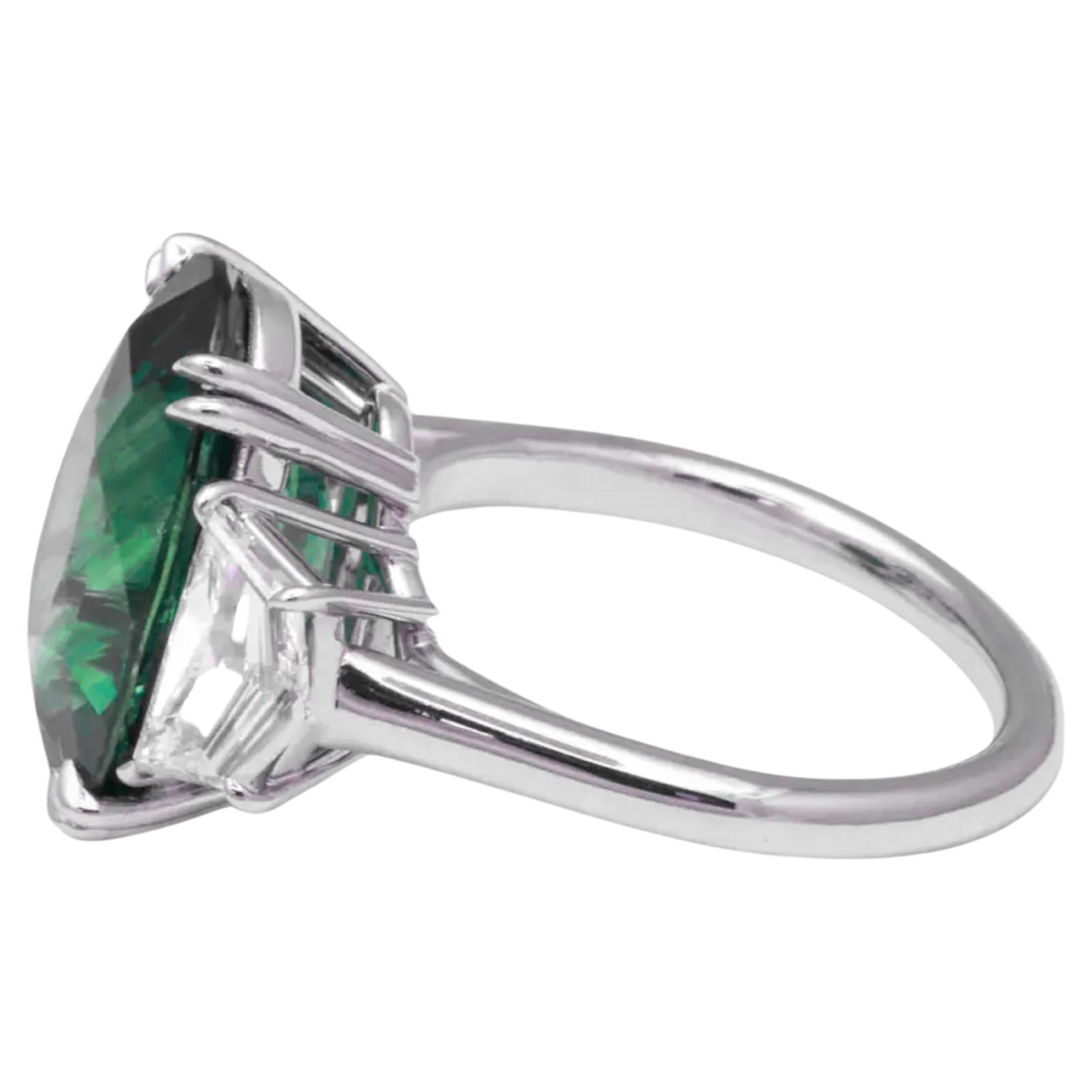 An exceptional treasure, this GIA-certified 7.26-carat Muzo Colombian emerald ring is a masterpiece of color and craftsmanship. Set in platinum and flanked by two dazzling half-moon diamonds, this piece exudes timeless sophistication and