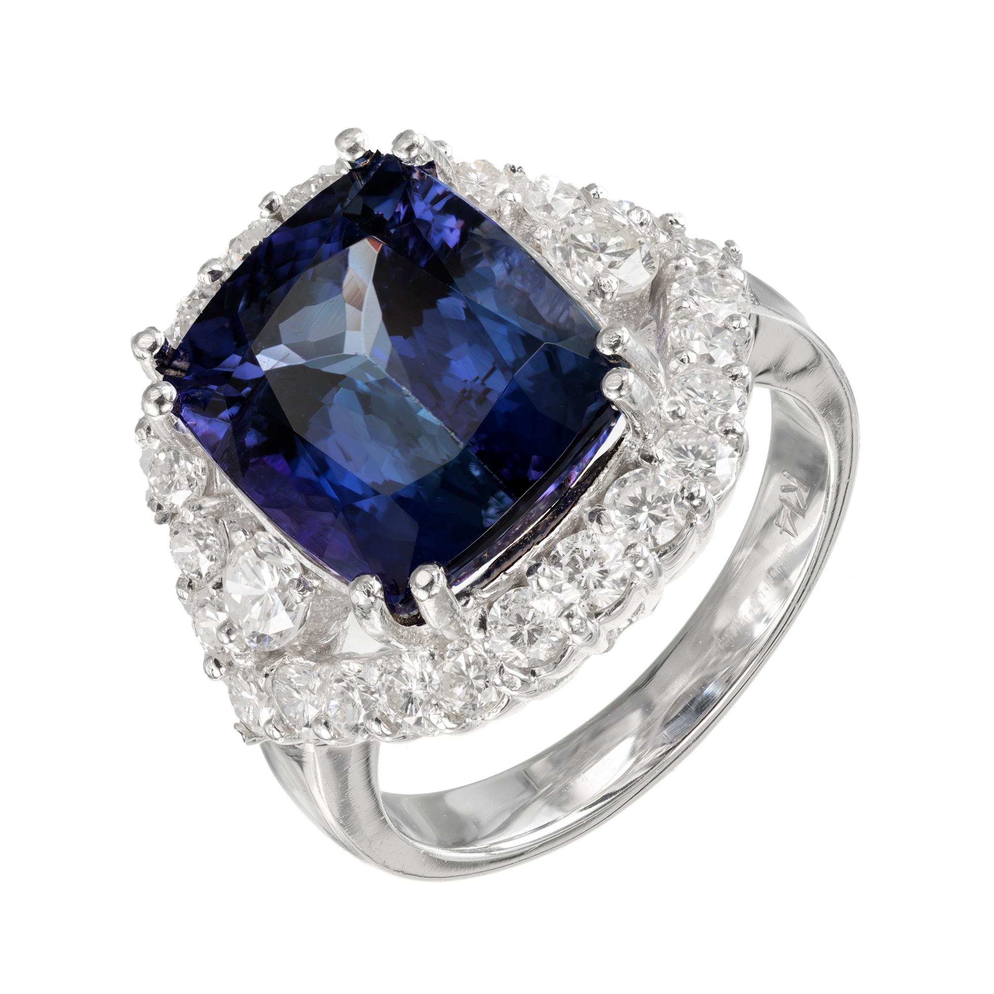 GIA certified blue-violet tanzanite and diamond halo cocktail ring. Cushion cut center stone with a split halo of round brilliant cut diamonds in a 14 white gold setting. 

1 cushion cut blue-violet SI tanzanite, Approximate 7.27cts GIA Certificate