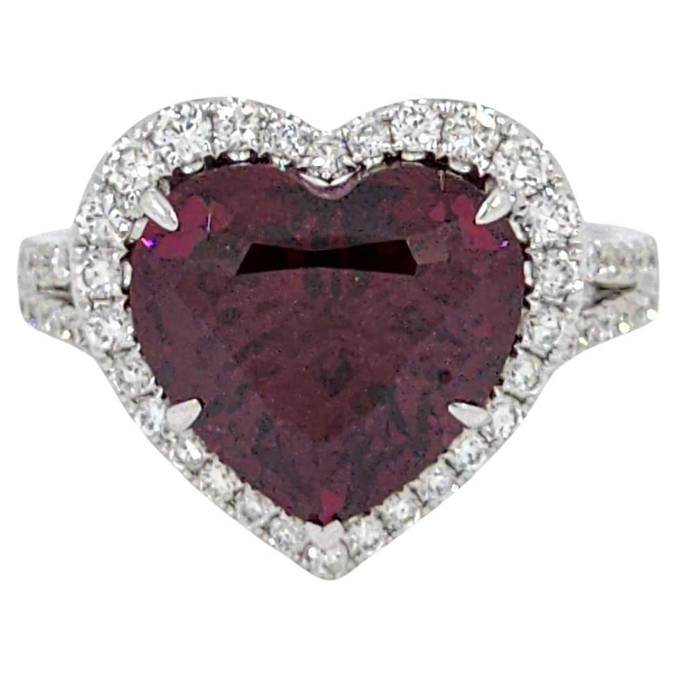 This ring, crafted in 18-karat white gold, boasts a captivating heart-shaped garnet, GIA certified at 7.37 carats. The garnet’s deep burgundy color is rich and intense, symbolizing love and devotion, making this ring an ideal romantic gift. The