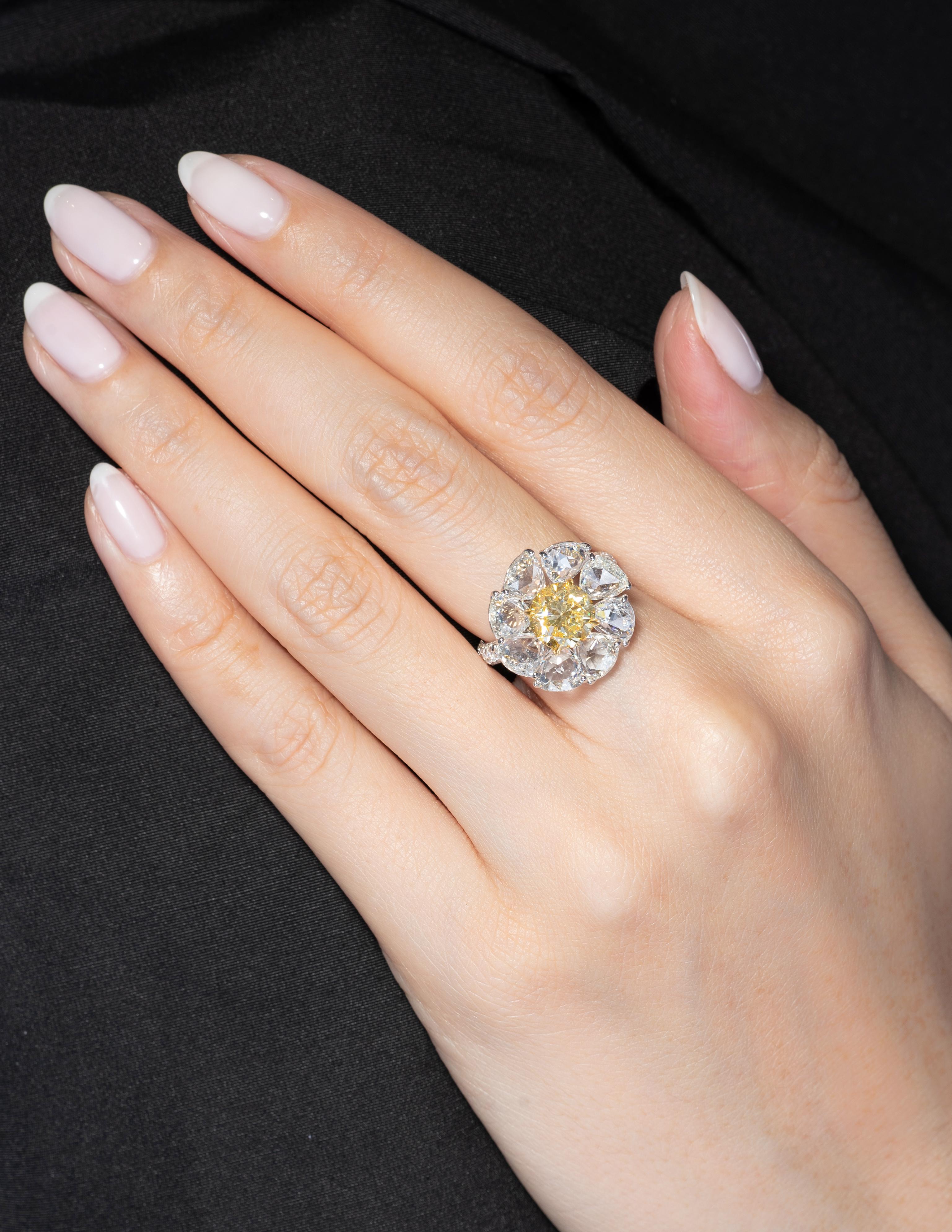 This piece is available for custom order only. 

This ring will always put a smile on your face! Our special daisy diamond ring features a 2.09ct round brilliant Fancy Yellow Diamond that has been GIA Certified #1162731886 (VVS2 clarity) and 4.40cts