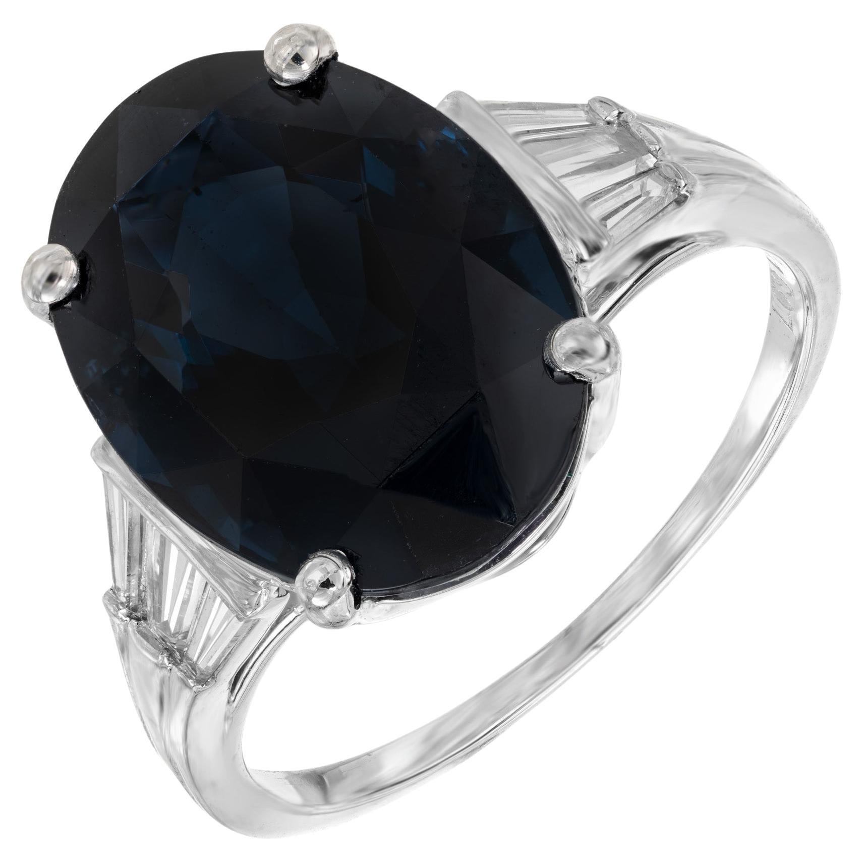 Mid-Century beautiful spinel and diamond engagement ring. GIA Certified oval dark blue spinel in its original handmade 1950's platinum setting, accented with 3 tapered baguette diamonds on each side. GIA has certified as a natural spinel. 

1 oval