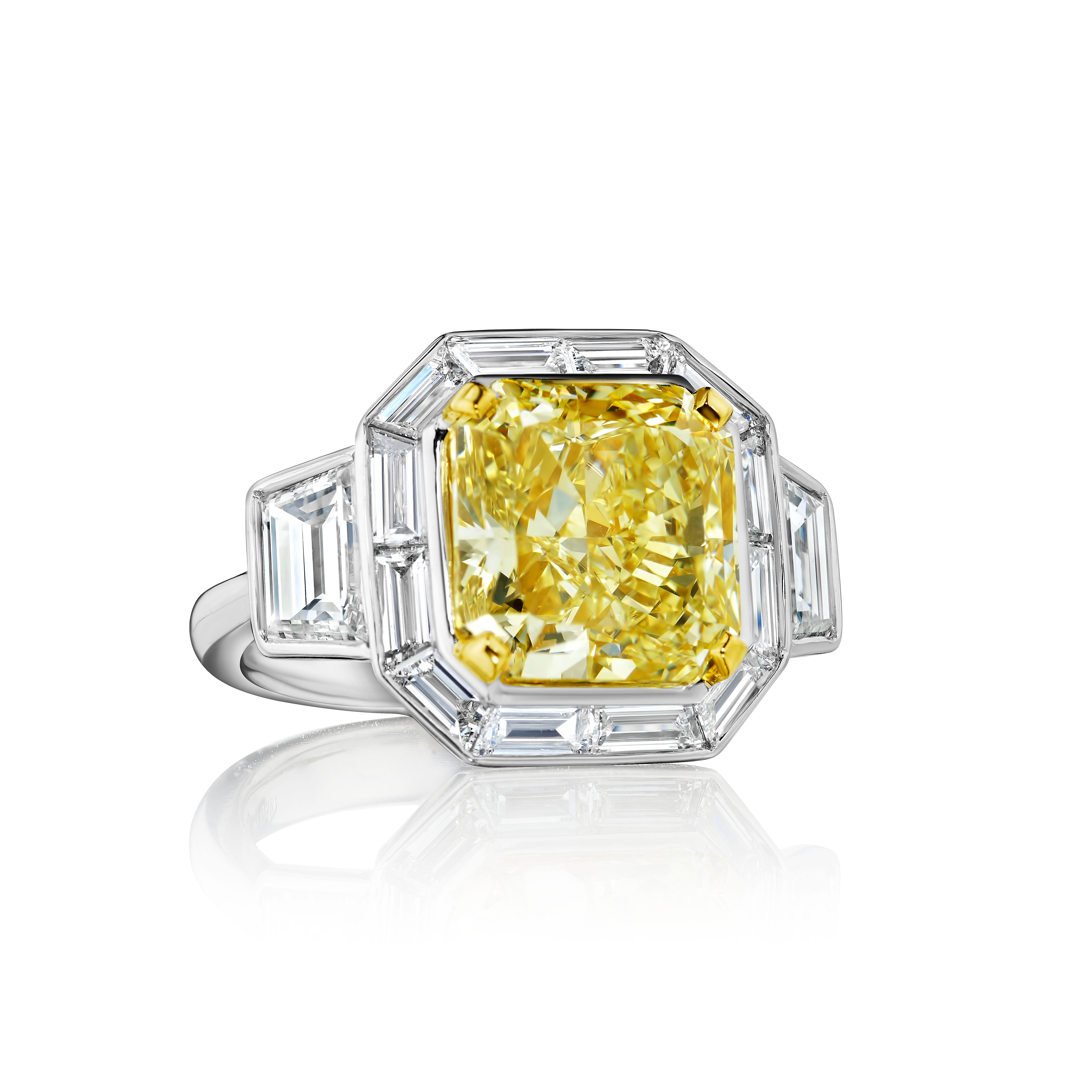 A very unique ring of the highest craftsmanship. Ultimate Sophistication and Class. 
Radiant Cut Diamond weighing 7.43 Carats, certified as Fancy Light Yellow, VS1 clarity. 
Trapezoid sides weighing 1.53 carats. 
Baguette and Trapezoid diamonds