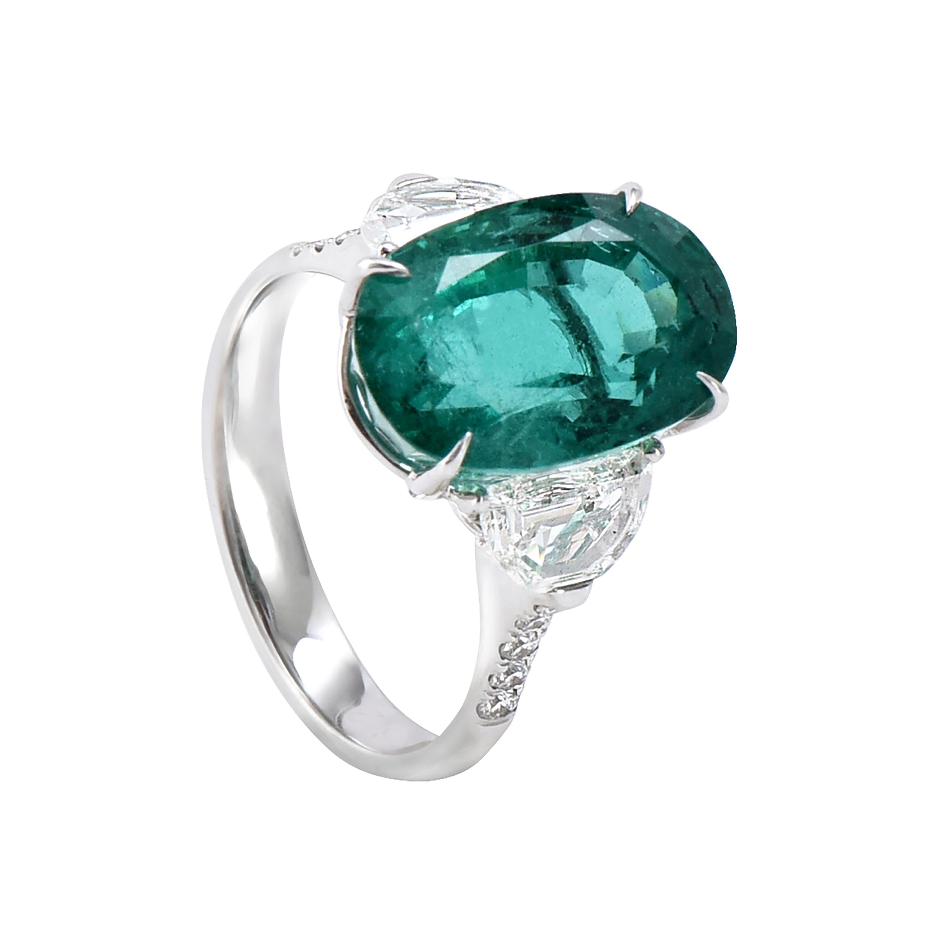 18 karat white gold emerald ring from the Princess collection of Laviere. The ring is set with a GIA certified 7.49 carats Zambian emerald, 0.15 carats round brilliant cut diamonds and two half moon cut diamonds totaling 0.89 carats.  
Gold Weight