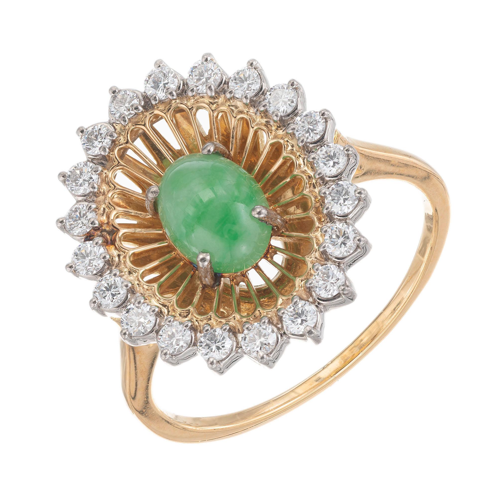 Vintage 1950's jade and diamond cocktail ring. GIA certified oval center jade with an outer halo of twenty round diamonds in an 18k yellow gold setting. 

1 oval cabochon green jadeite jade, approx. .75cts GIA certificate #2215095464
20 round