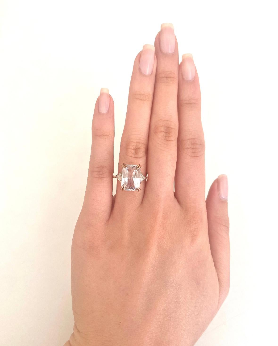 Discover understated elegance with this GIA Certified 3-Stone Light Pink Sapphire Ring featuring radiant cut sapphire and trillion cut diamonds. The natural octagonal-shaped light pink sapphire exudes a subtle charm, complemented by the brilliance